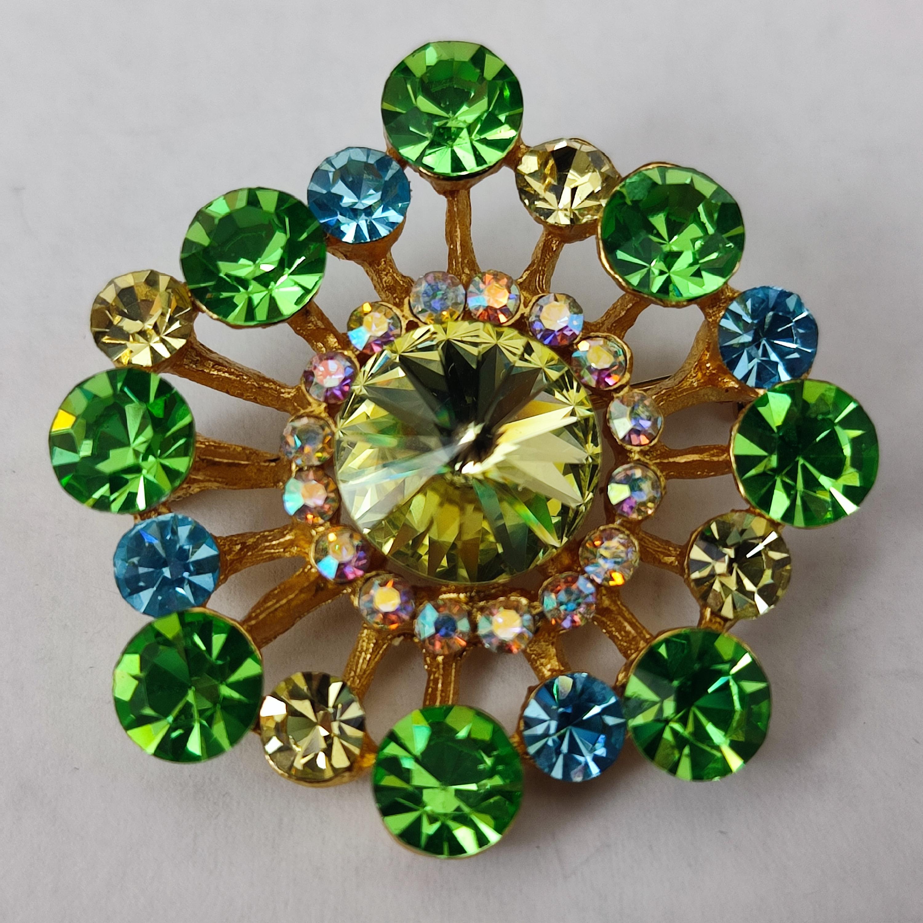 Vintage Guy Laroche Brooch, made of green, blue and clear crystal inserted in a golden structure. Marked on the reverse. 
Condition: Excellent condition.
Materials and Techniques: gilt metal, colored Rhinestones
Marks: Guy Laroche, Paris
Date of