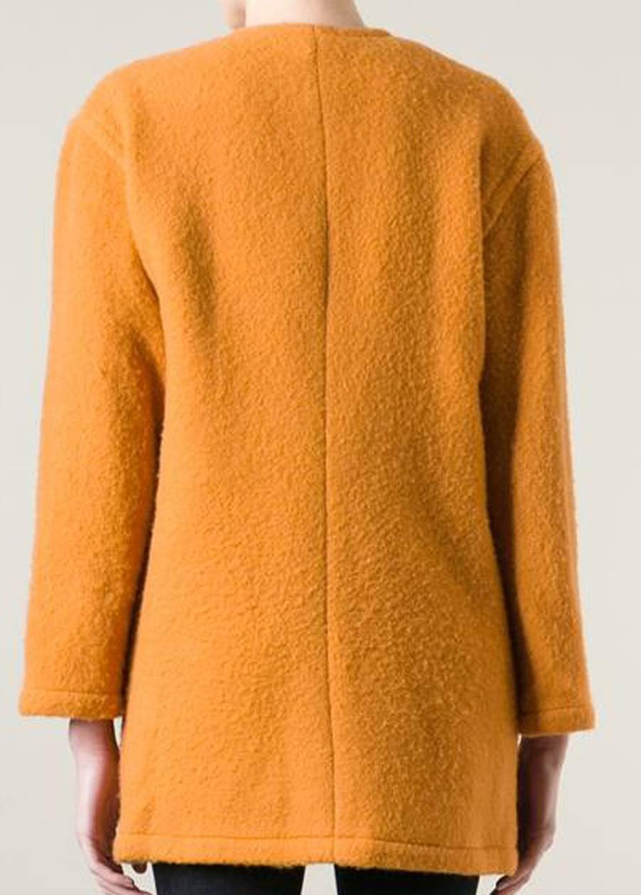 Guy Laroche sunflower unlined wool-mohair blend single breasted coat featuring a collarless design, a front button fastening, front pockets, long sleeves and gold-tone round buttons. (90%wool, 10%mohair)
In good vintage condition. Made in