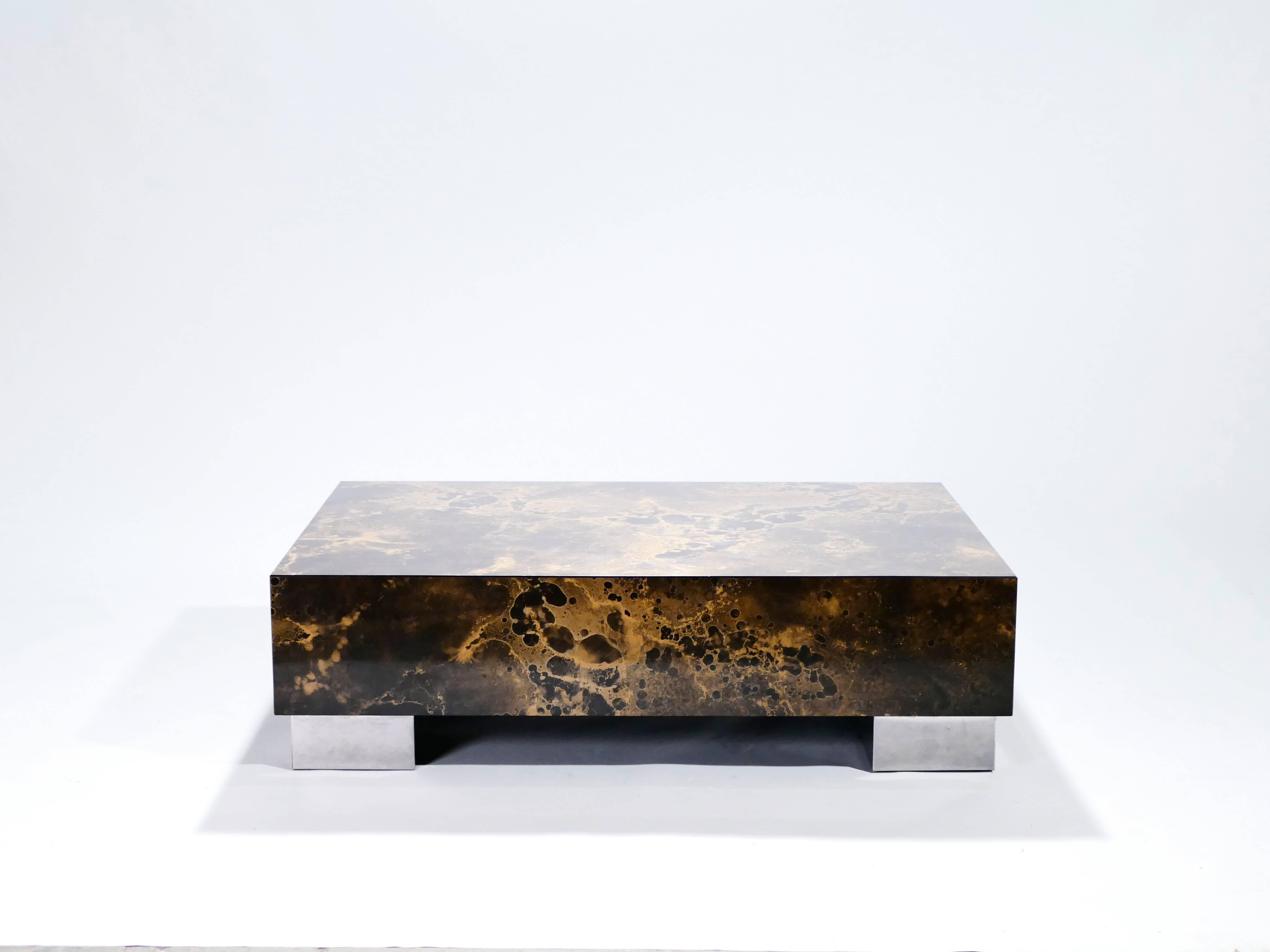 The boxy, clean design of this coffee table, by Guy Lefevre for Ligne Roset, balances the best of Mid-Century Modern design with a contemporary look. Chunky feet made from polished steel lend it a sturdy appearance and indeed this piece is quite