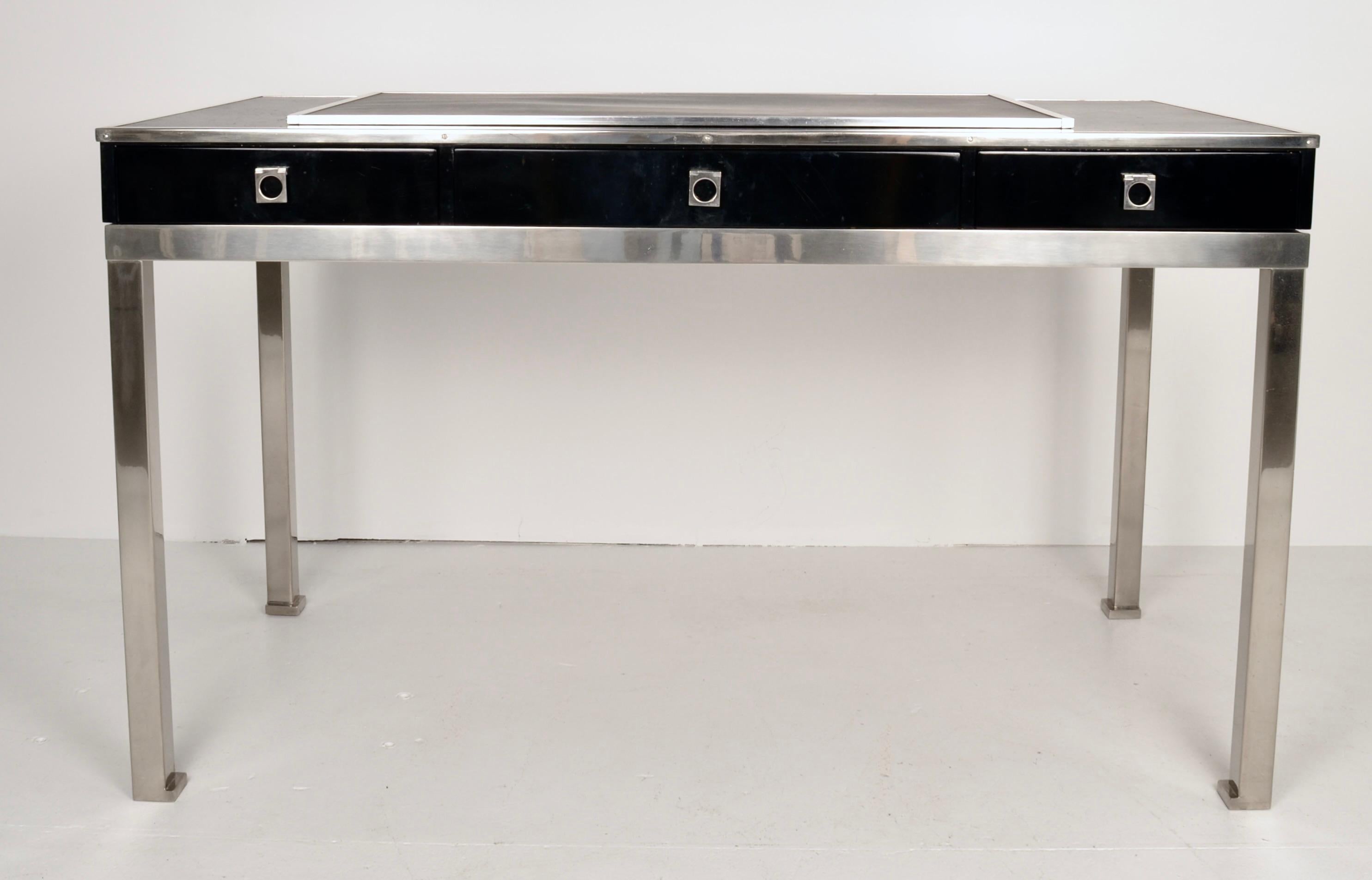 Designed by noted designer Guy LeFevre who worked extensively with Maison Jansen in the 1970s, this handsome desk incorporates many of his signature details. The base and hardware are polished steel, the sides and three drawers have a high gloss