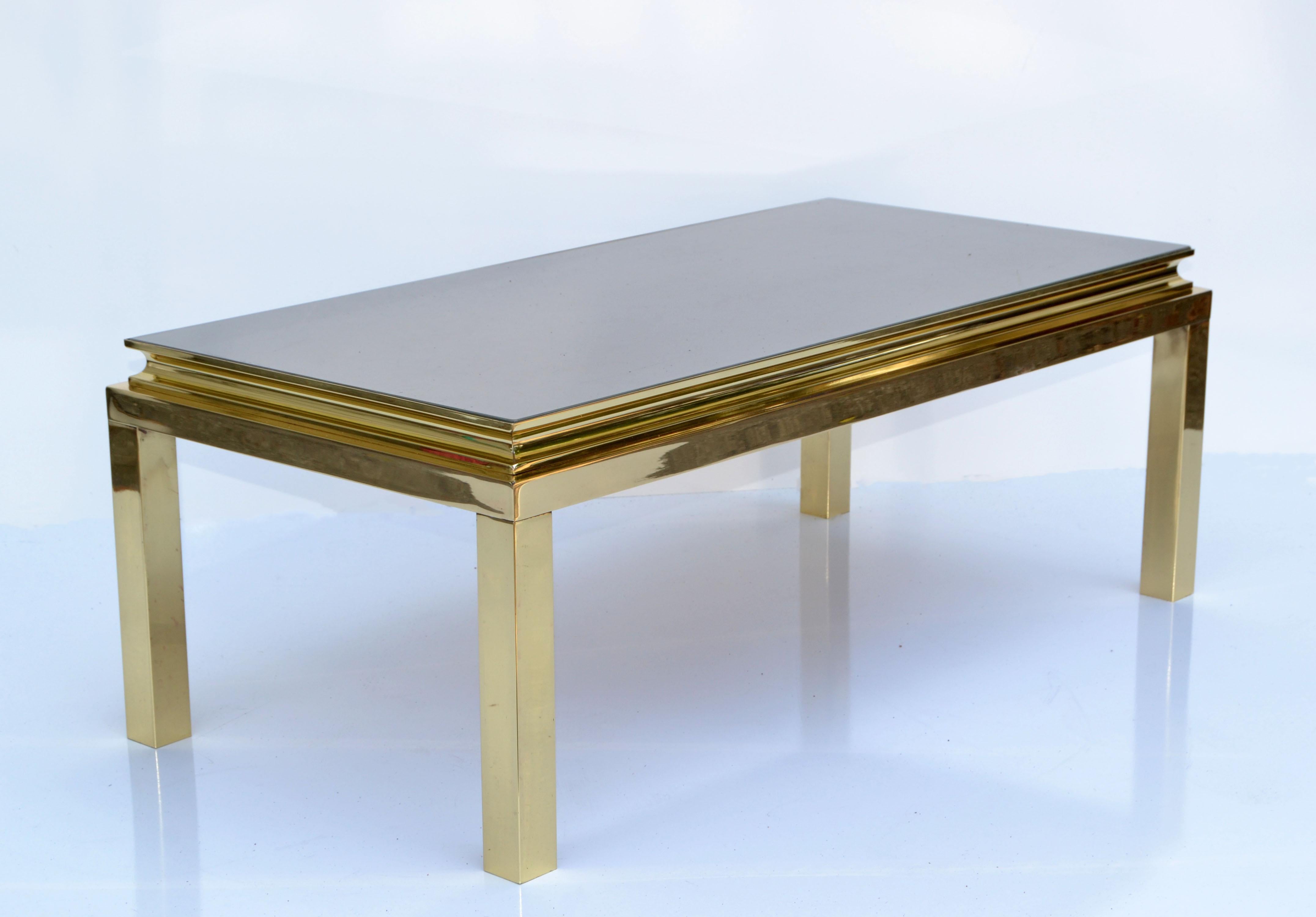 Guy Lefevre for Maison Jansen French 1960 rectangle coffee table featuring a polished brass frame and a vintage gold mirror Glass Top.
Brass is newly polished and the original Mirror Glass has some scratches due to History.
Mirrored Glass