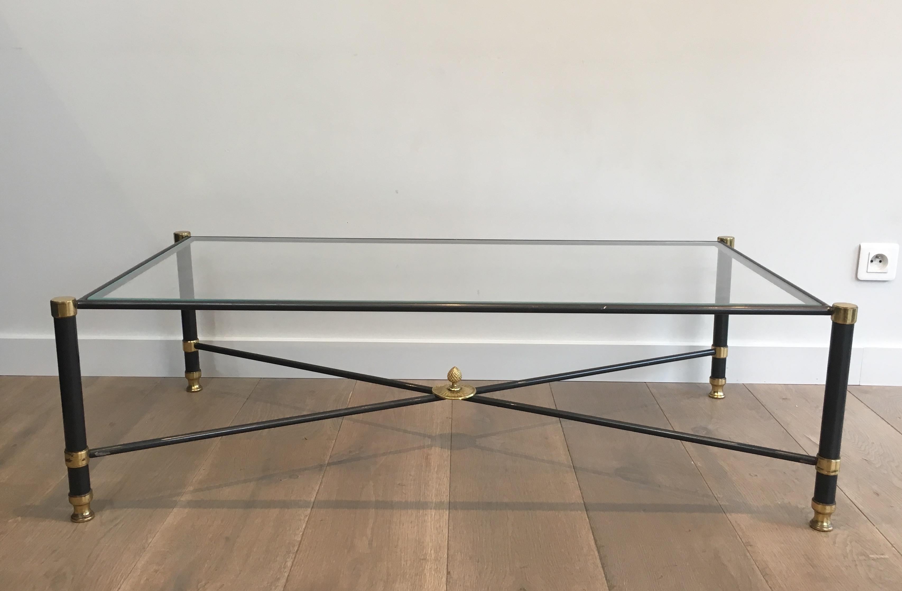 This very nice and elegant neoclassical style coffee table is made of gun metal and brass with a clear glass top. This is a cocktail table by famous French designer Guy Lefevre for Maison Jansen, circa 1970.