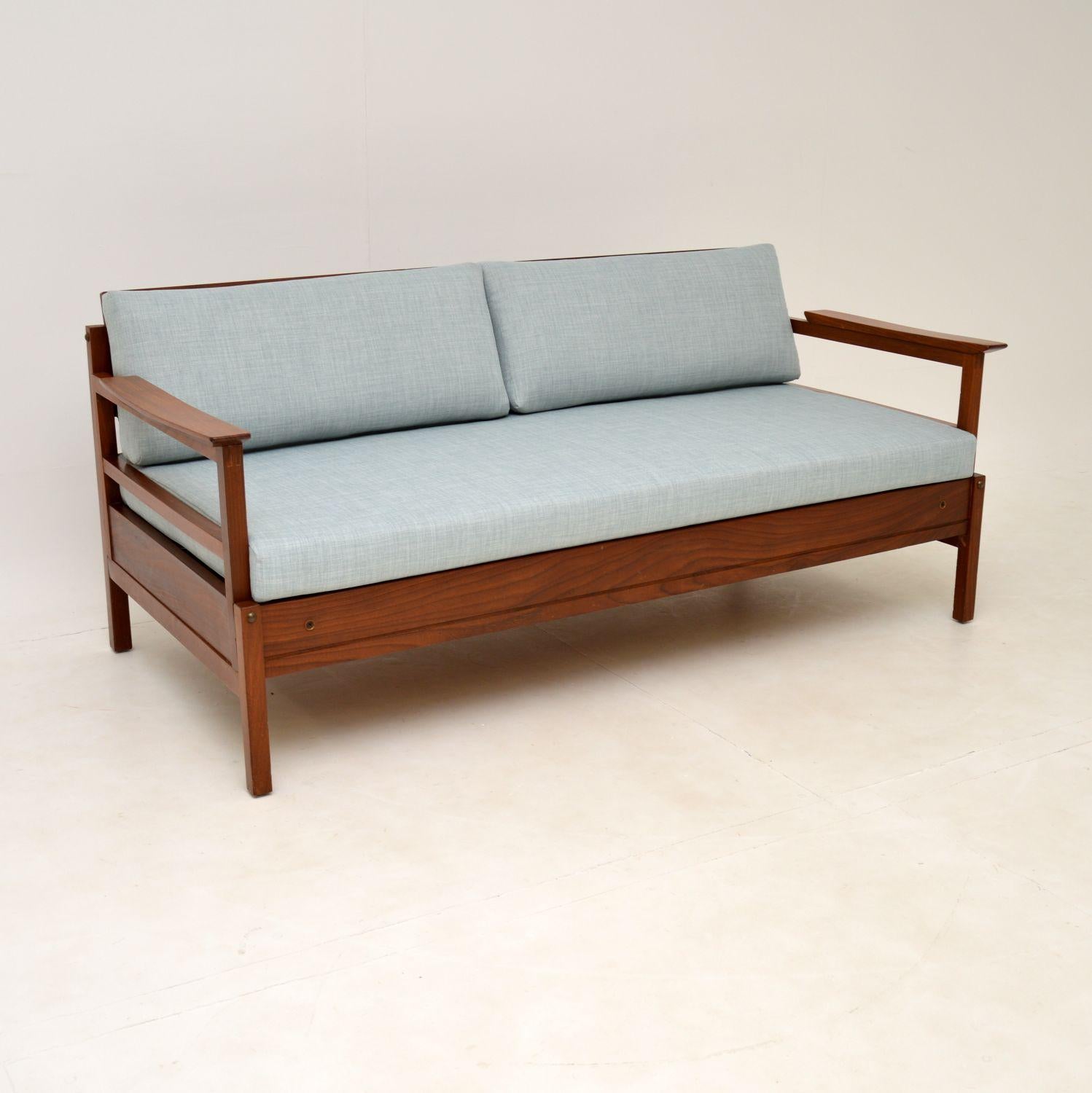 A stylish and very rare vintage ‘Gambit’ sofa bed by Guy Rogers. This was made in England during the 1960’s.

The frame is solid afromosia wood, which has gorgeous grain patterns and a beautiful, rich colour. The cushions have been newly made and