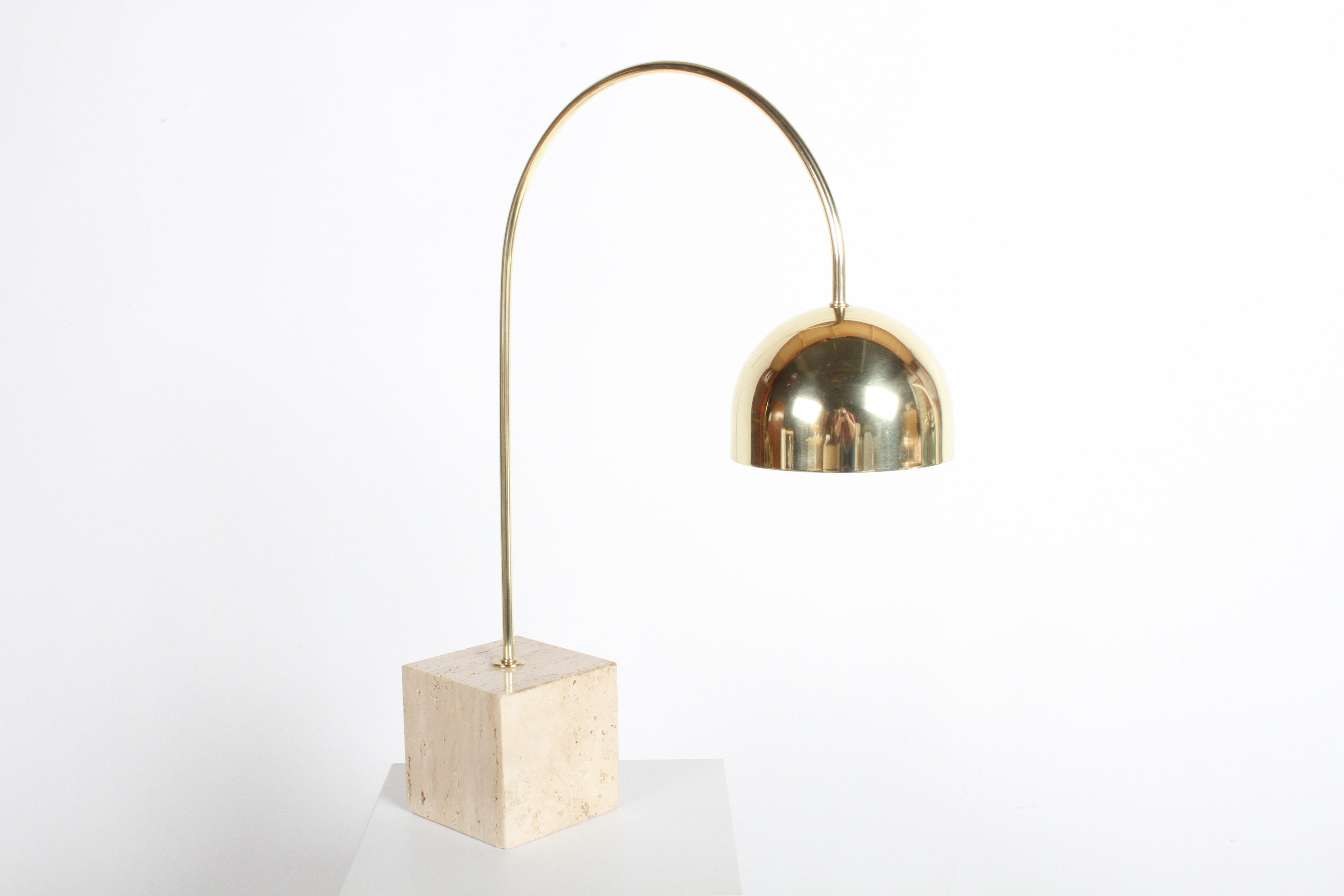 Beautiful Harvey Guzzini brass arc table lamp on travertine base. Brass arm and shade have been polished to a warm butler finish and lacquered. Inside the shade has new white paint. Has been rewired with new clear cord that has inline on/off switch.