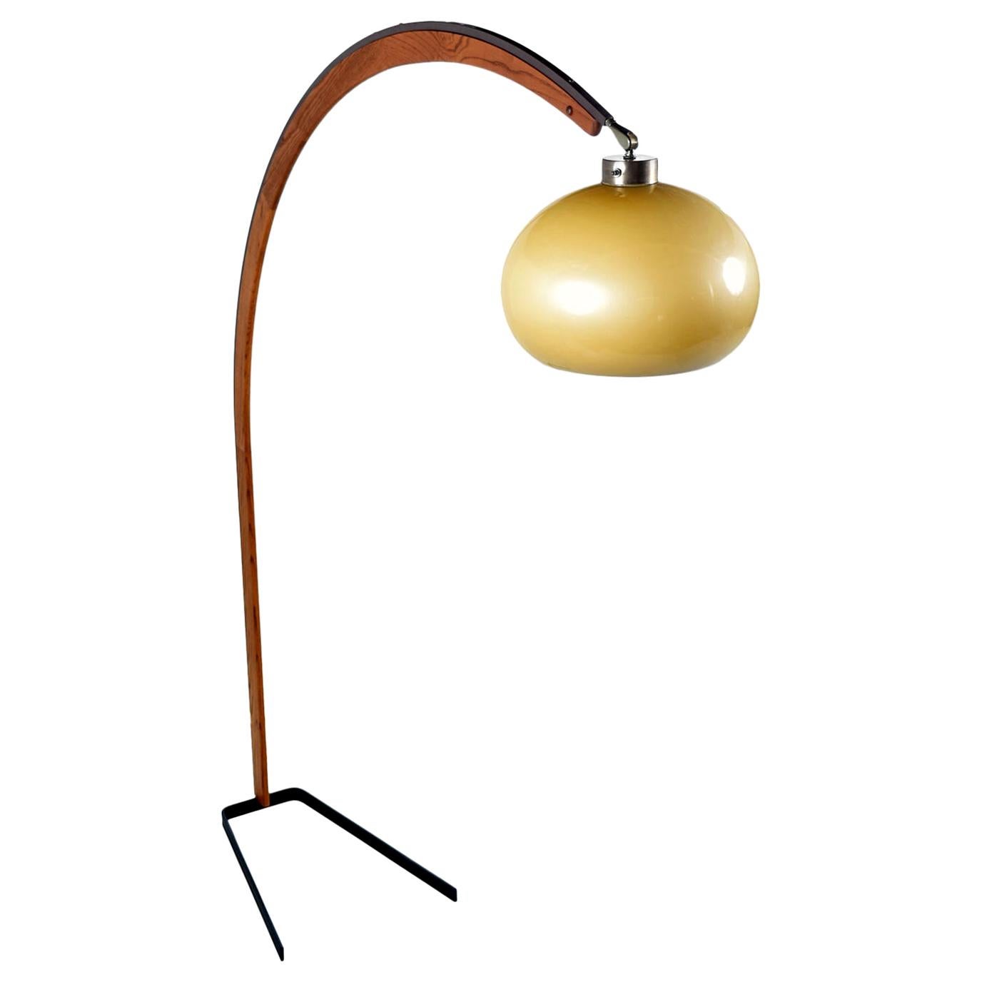 Solid American oakwood enhances the form of this arc lamp by Nova Lighting. This Postmodern design is a fresh take on the iconic arc lamp by Harvey Guzzini. The lamp is both sturdy and beautiful with more visual presence than the Minimalist Guzzini