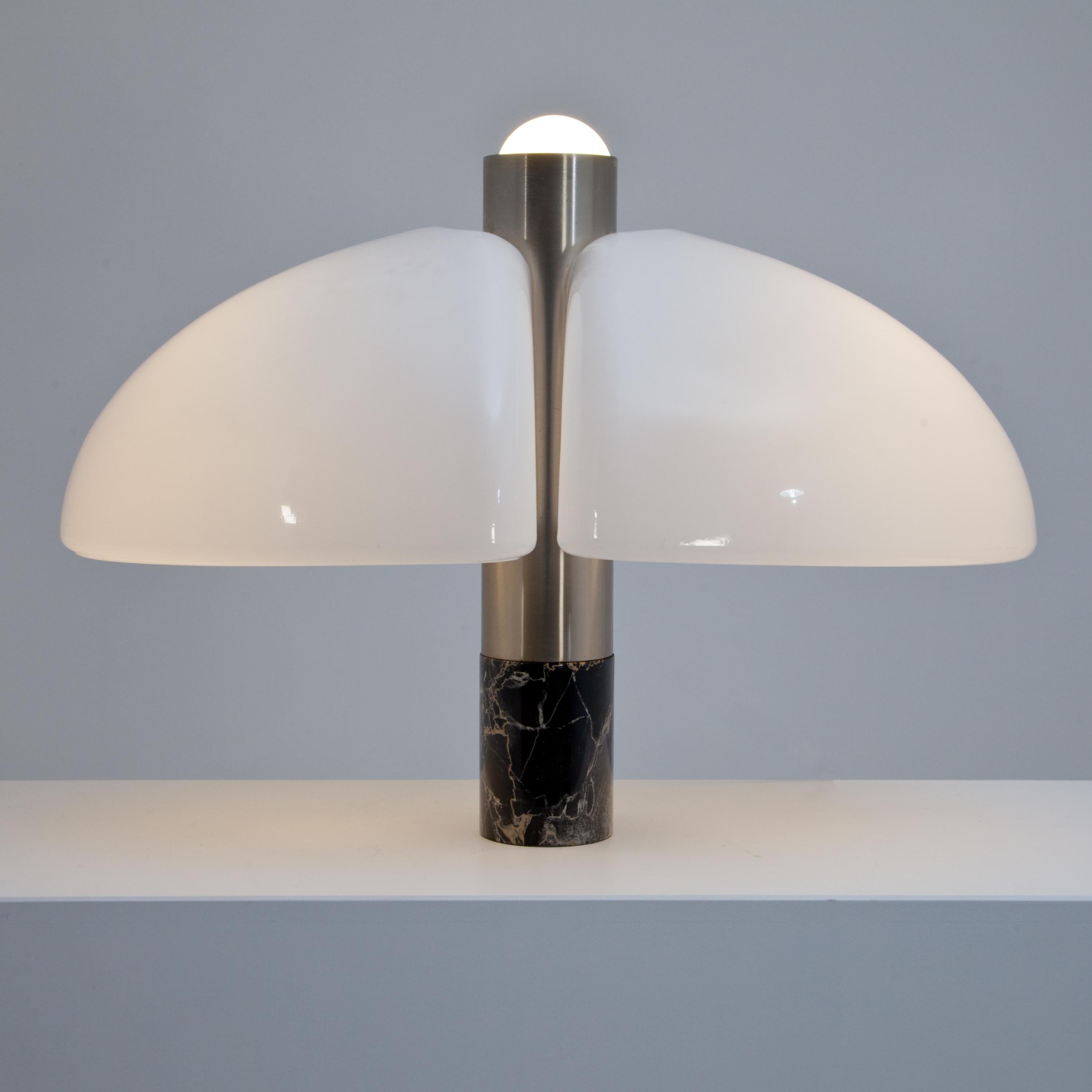 Table lamp with white plexiglass hood-shaped shade and base in black marble and aluminium.