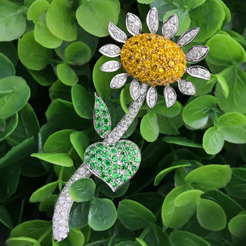 Designed by the master craftsman of g. Verdi of Italy. This sunflower brooch is very special, with 14 petals and stem pave set with round brilliant diamonds. The center pistil is set with round brilliant yellow sapphires and the leaves are set with