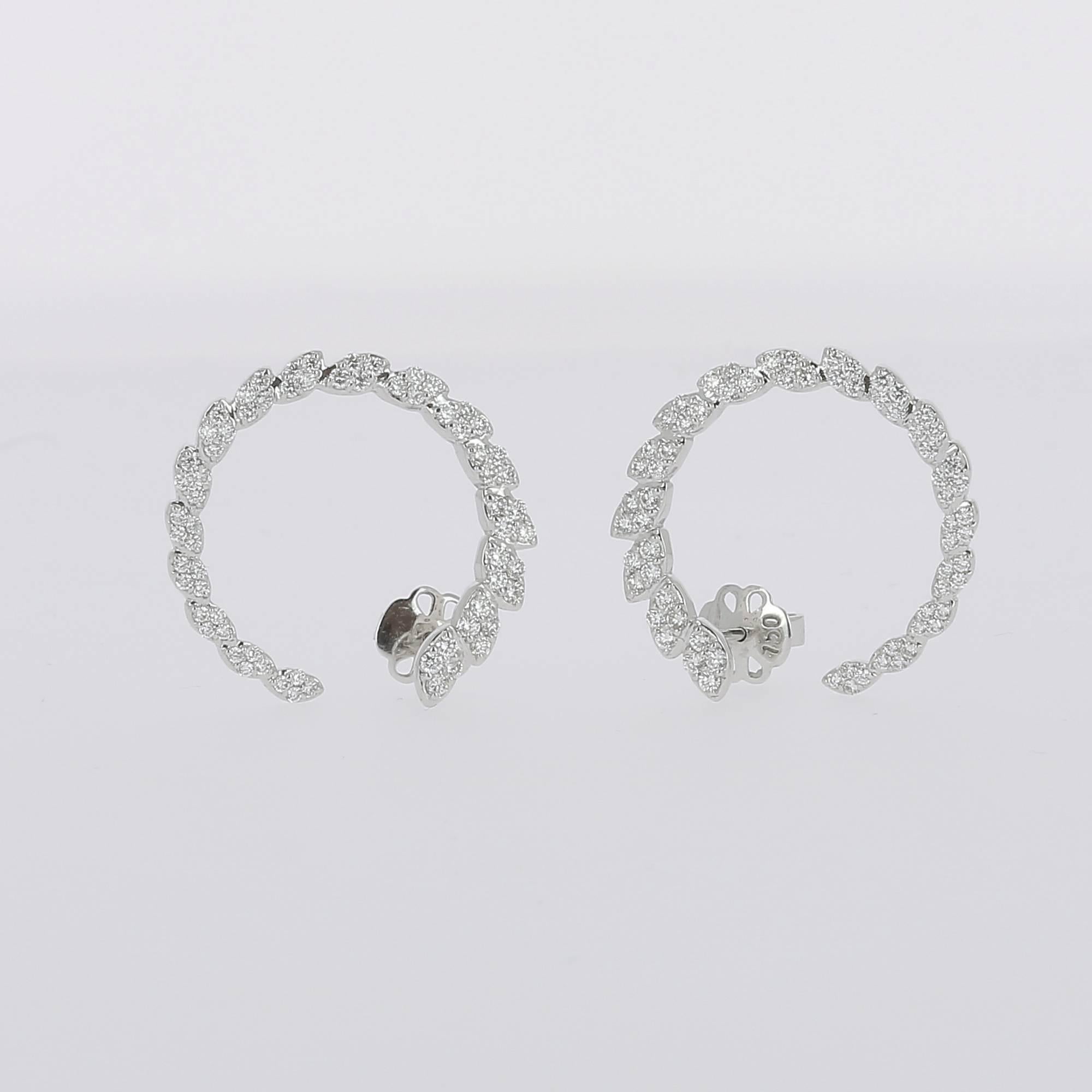 Earrings set with 17 oval parts paved with Round Diamonds weighing 1.81 carats.
The Diamonds are GVS qualities.
The Clip-on Earrings is 18K White Gold.
