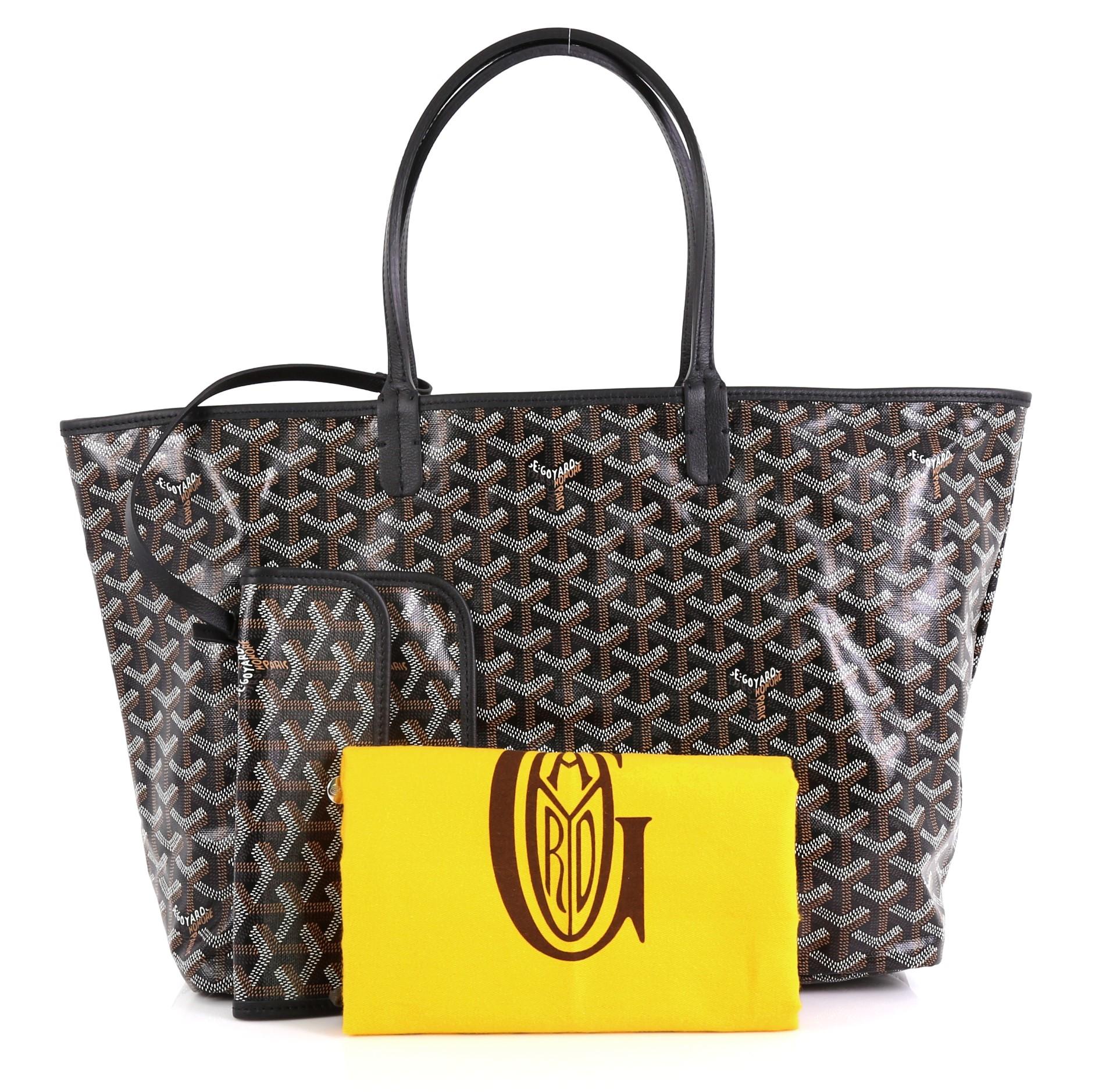 This Goyard St. Louis Tote Coated Canvas PM, crafted from black coated canvas, features dual slim leather handles, leather trim, and silver-tone hardware. Its wide open top showcases a neutral canvas interior. 

Condition: Excellent. Light wear in