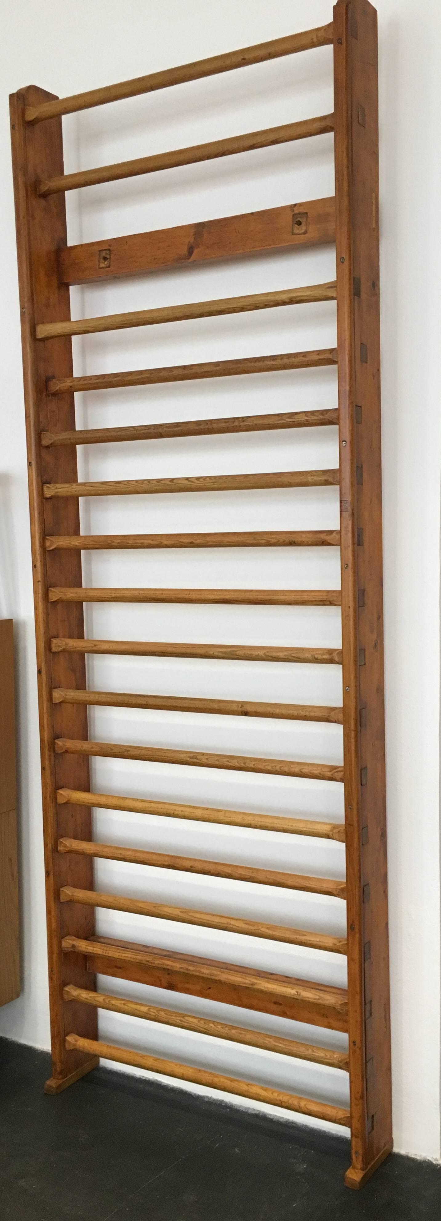 This wall bar from an old gym was completely restored, the wood shows a beautiful patina. Whether for a daily workout or as an object that also serves as a clothes rack or towel rack, this wall bars is definitely a real eye-catcher.
 