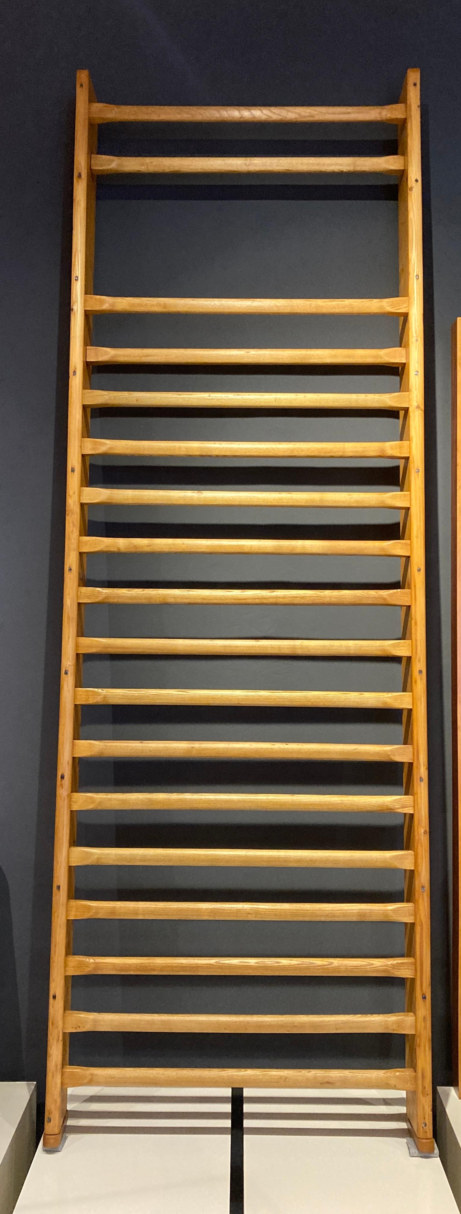 This wall bar from an old gym was completely restored, the wood shows a beautiful patina. Whether for a daily workout or as an object that also serves as a clothes rack or towel rack, this wall bars is definitely a real eyecatcher.