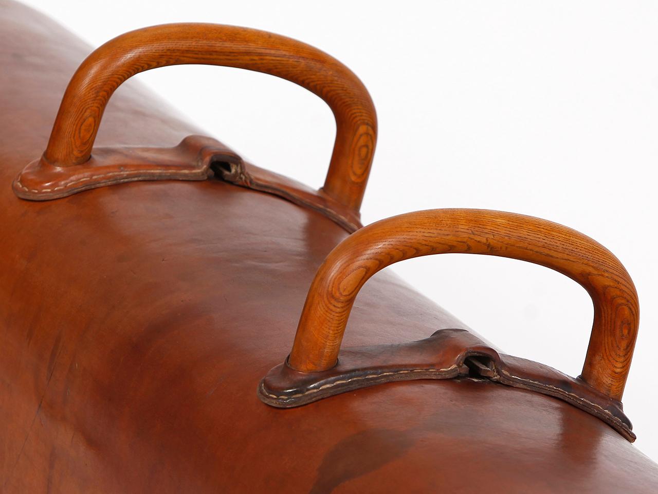Pommel horse from former Czechoslovakia. It has been shortened to a height of 53 cm. The iron feet are preserved. The thick leather has been cleaned and preserved, restored wood surface and the patina was retained the wooden handles were restored