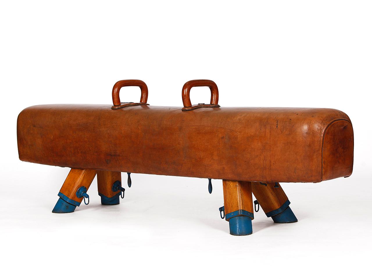 Pommel horse from former Czechoslovakia from the 1930s with beautiful patina, shortened to bench height 50cm and very good vintage condition. Completely restored. The iron feet are preserved. The thick leather has been cleaned and preserved,