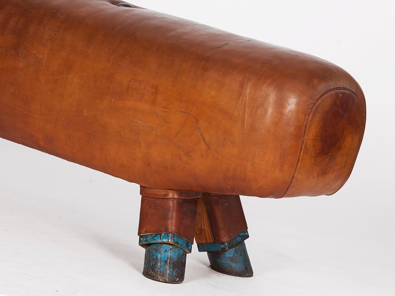 Pommel horse from former Czechoslovakia from the 1930s with beautiful patina, shortened to bench height 52cm and very good vintage condition. Completely restored. The iron feet are preserved. The thick leather has been cleaned and preserved. All of