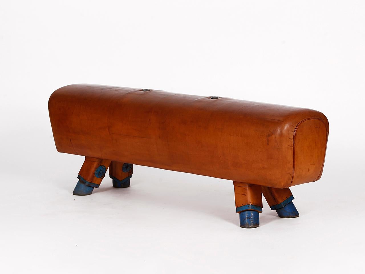 Pommel horse from former Czechoslovakia from the 1930s with beautiful patina, shortened to bench height 53cm and very good vintage condition. Completely restored. The iron feet are preserved. The thick leather has been cleaned and preserved. All of
