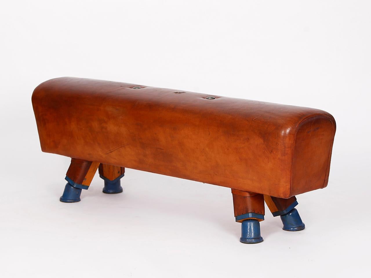 Pommel horse from former Czechoslovakia from the 1930s with beautiful patina, shortened to bench height 55cm and very good vintage condition. Completely restored. The iron feet are preserved. The thick leather has been cleaned and preserved. All of