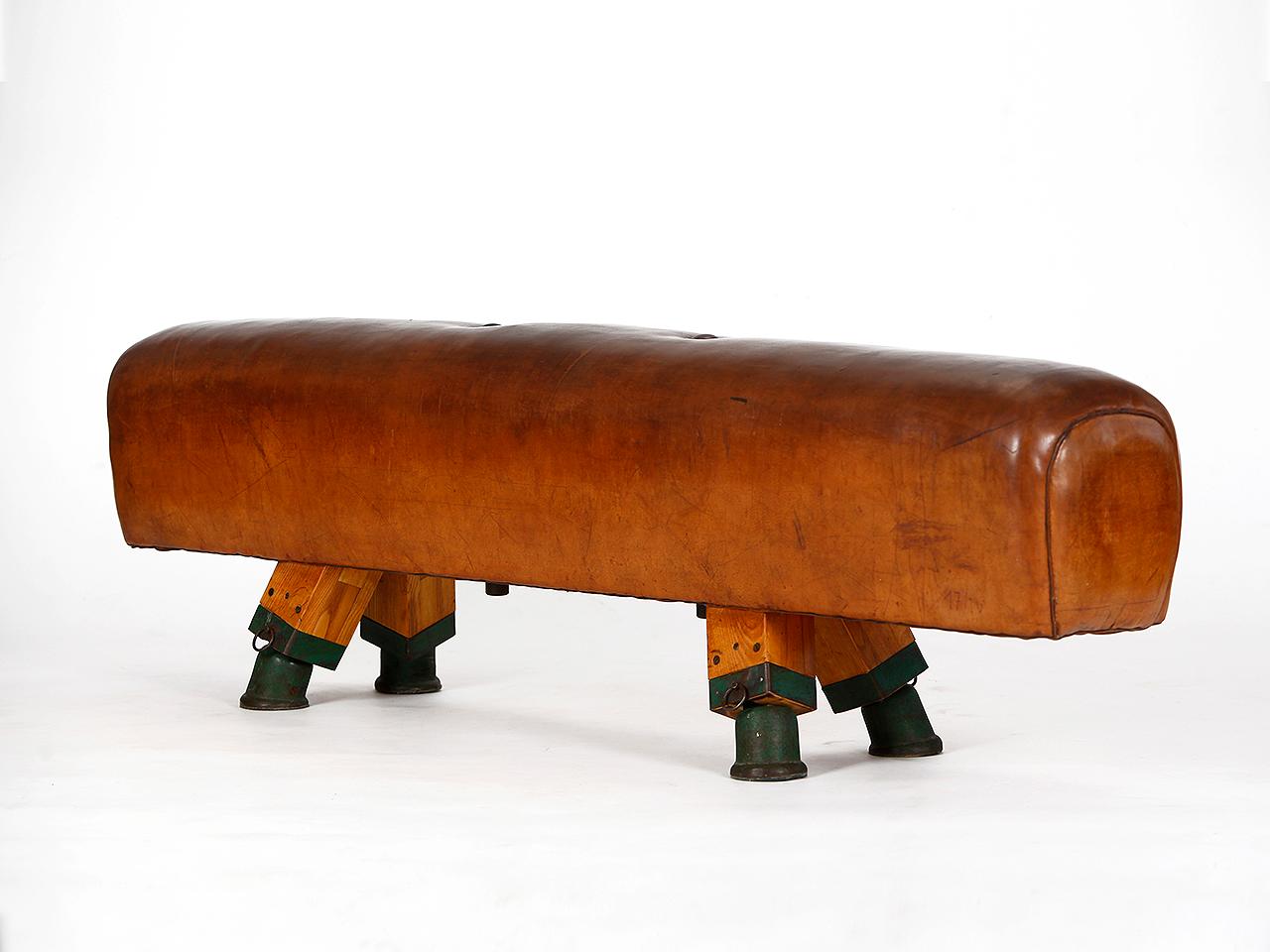 Pommel horse from former Czechoslovakia. It has been shortened to a height of 55 cm. The iron feet are preserved. The thick leather has been cleaned, restored wood surface and the patina was retained. Very good vintage condition. Completely