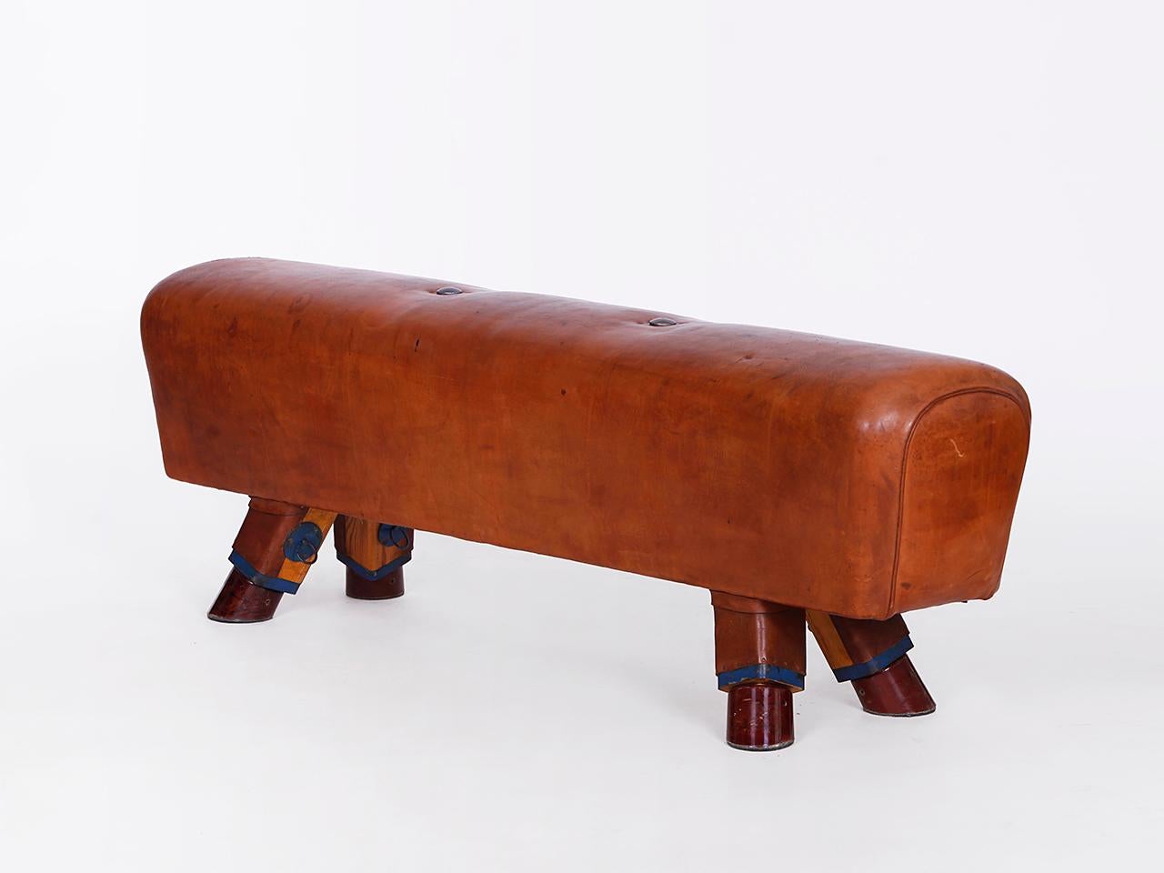 Pommel horse from former Czechoslovakia from the 1930s with beautiful patina, shortened to bench height 52cm and very good vintage condition. Completely restored. The iron feet are preserved. The thick leather has been cleaned and preserved. All of