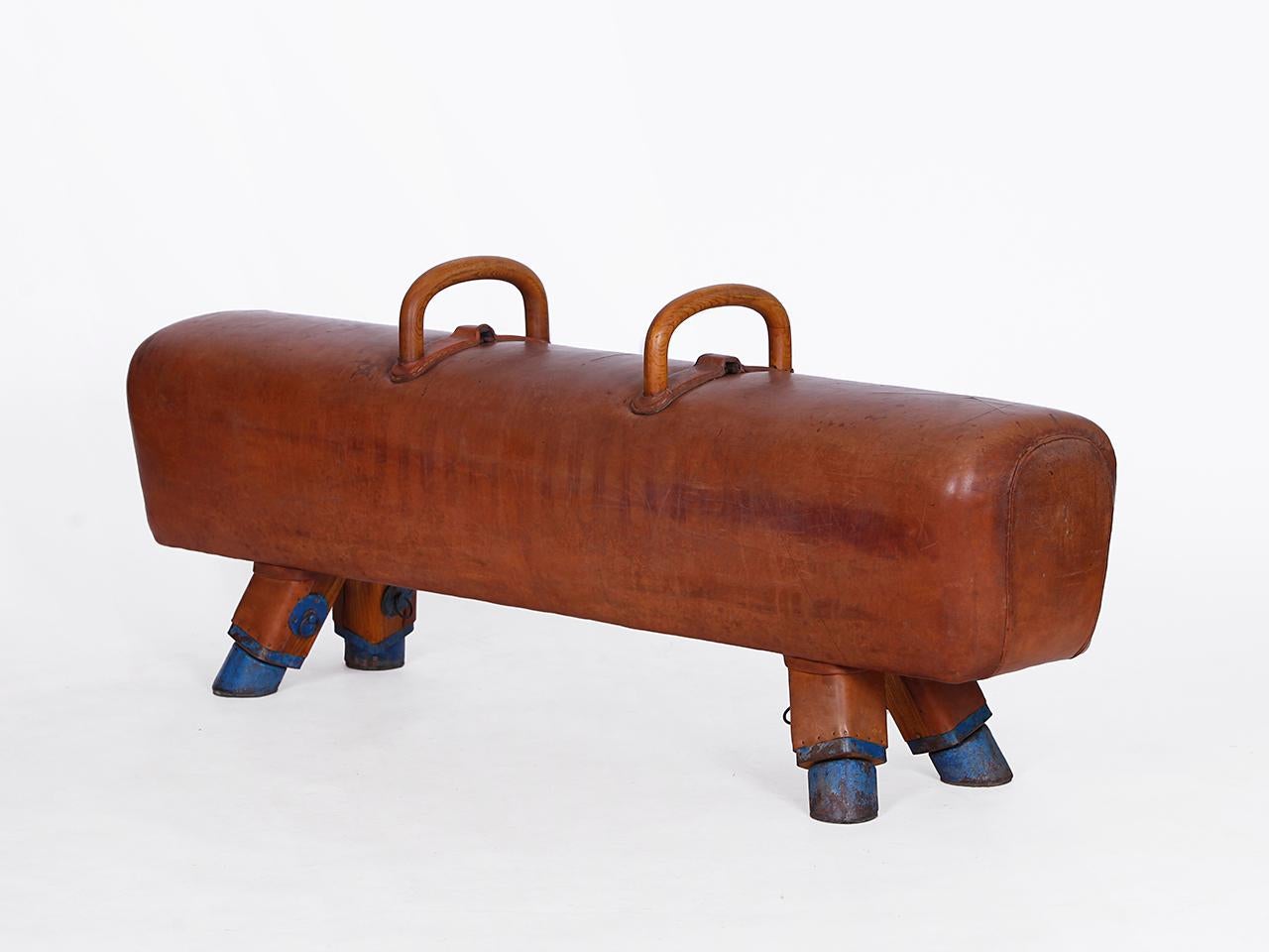 Pommel horse from former Czechoslovakia from the 1930s with beautiful patina, shortened to bench height 52cm and very good vintage condition. Completely restored. The iron feet are preserved. The thick leather has been cleaned and preserved,