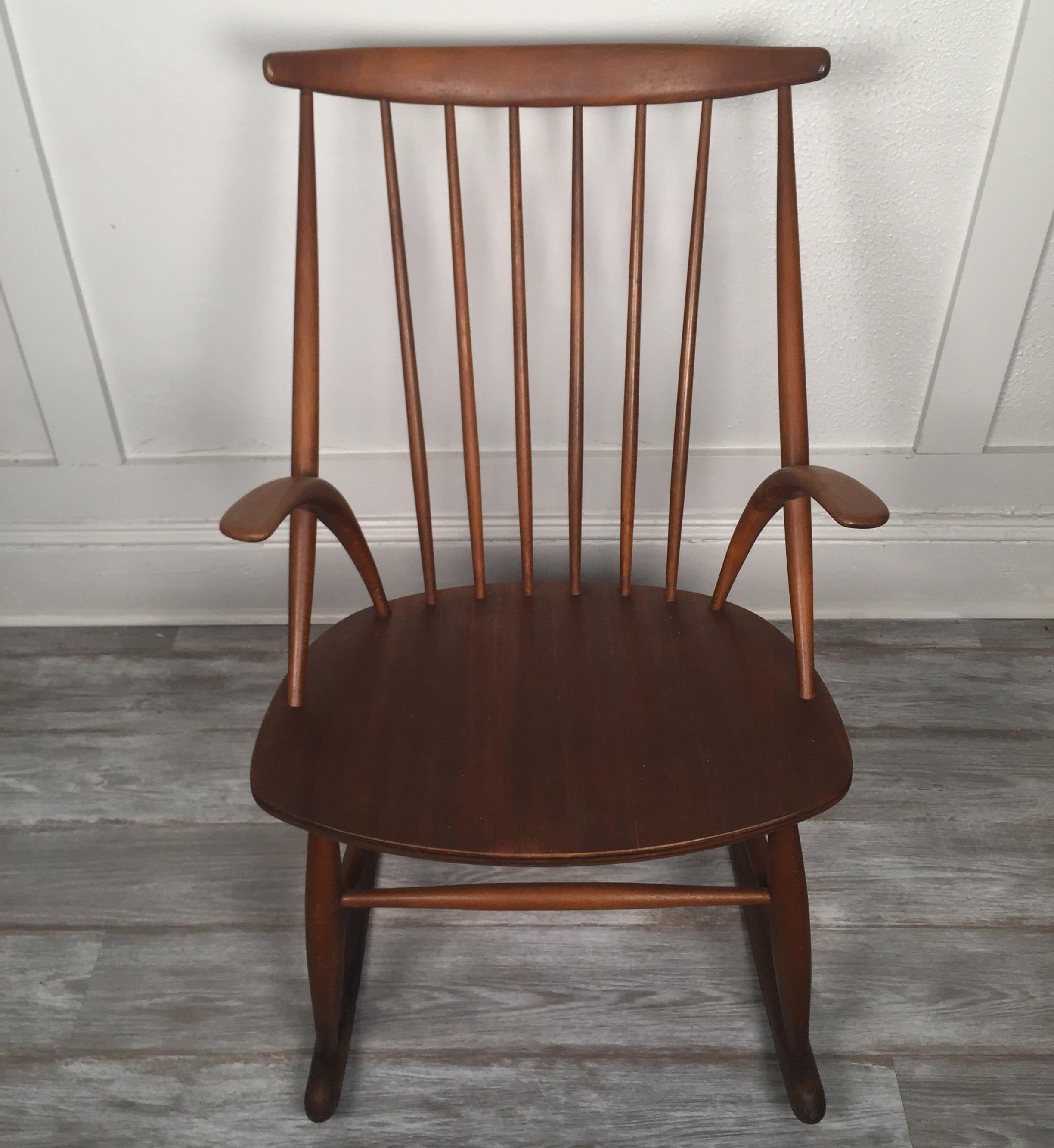 This rocking chair be Illum Wikkelsø for Neils Eilersen shows off the organic and subtractive design features that are hallmarks of Danish design in the mid-20th century. It features a solid stained beech frame and a molded mahogany plywood seat.