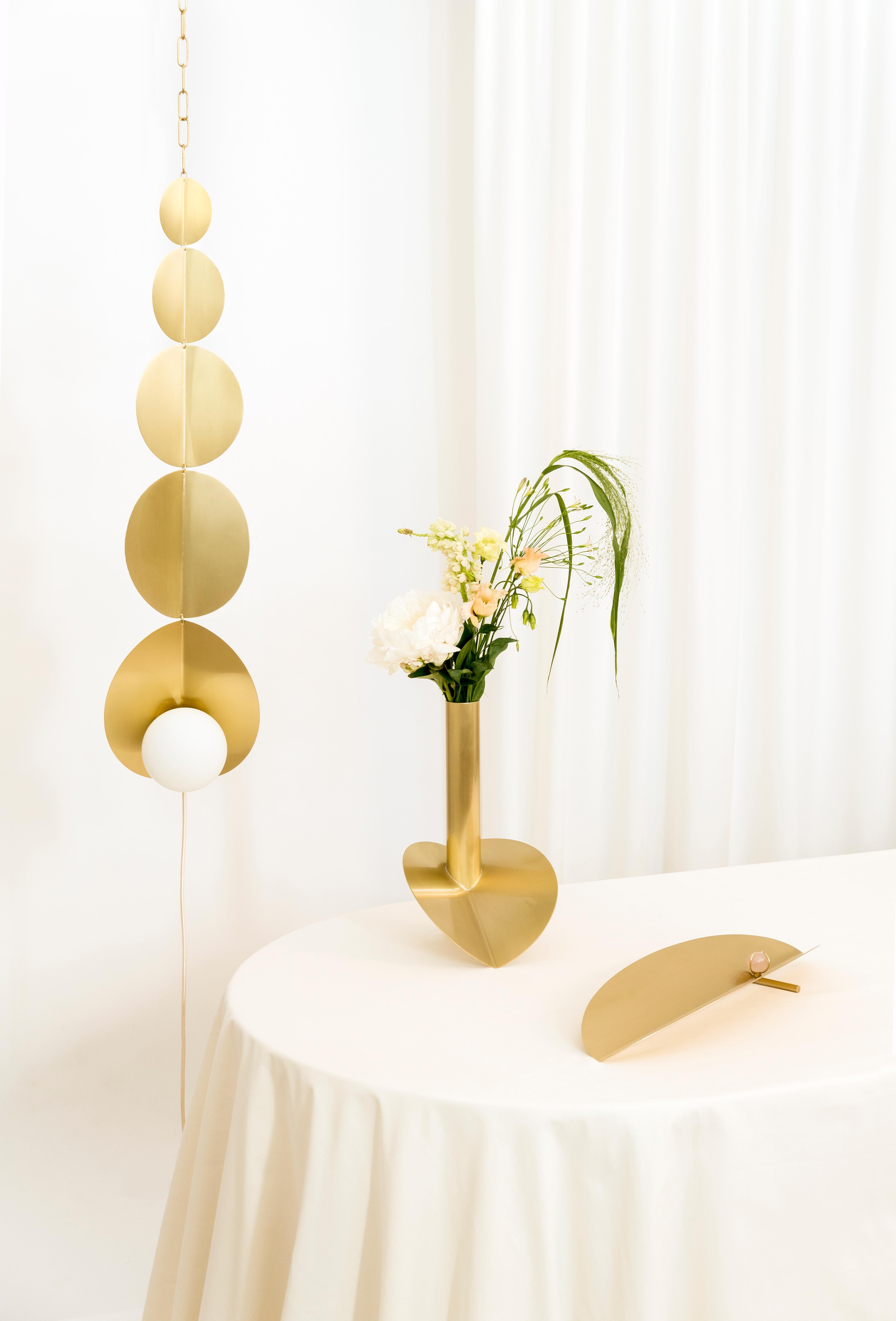 Gynoecium light mobile by Agustina Bottoni
One of a kind.
Materials: solid brass, frosted glass, LED lighting and textile cord.
Dimensions: W 15 x D 24 x H 90 cm.

A suspended sculptural lamp with delicate forms inspired by the botanical
