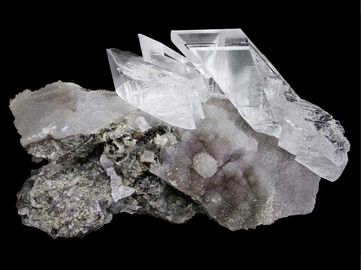 From Rio Grande do Sul, Brazil

 

Aesthetic cluster of colorless transparent gypsum selenite crystals on matrix with a partially coated with gradient white to purple (amethyst) quartz. The selenite crystals have water clear transparency with glassy
