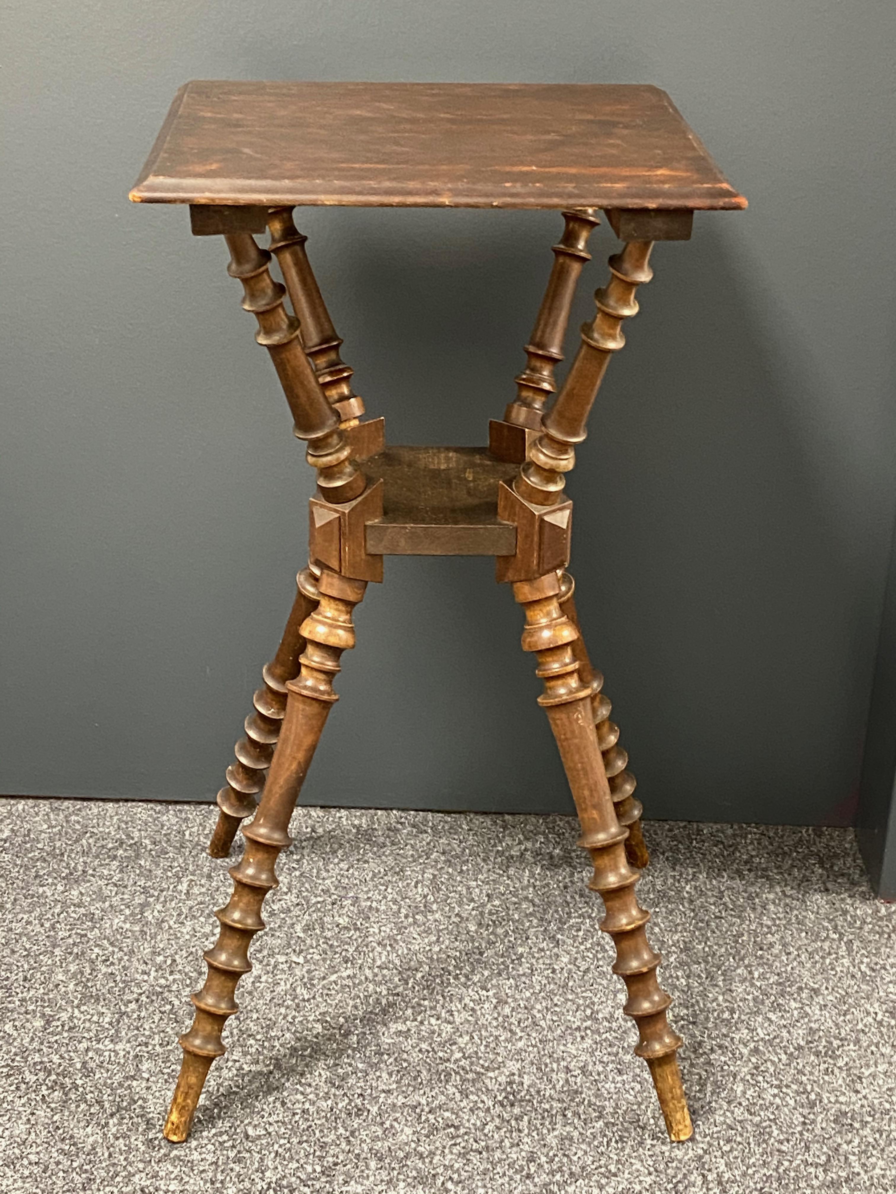 A beautiful wooden Gypsy style table. A pretty piece in the style known as a Gypsy table due to the formation of the crossed bobbin turned legs the table has a wooden top and turned legs. A great piece in good condition. The Table is 28 1/2” high