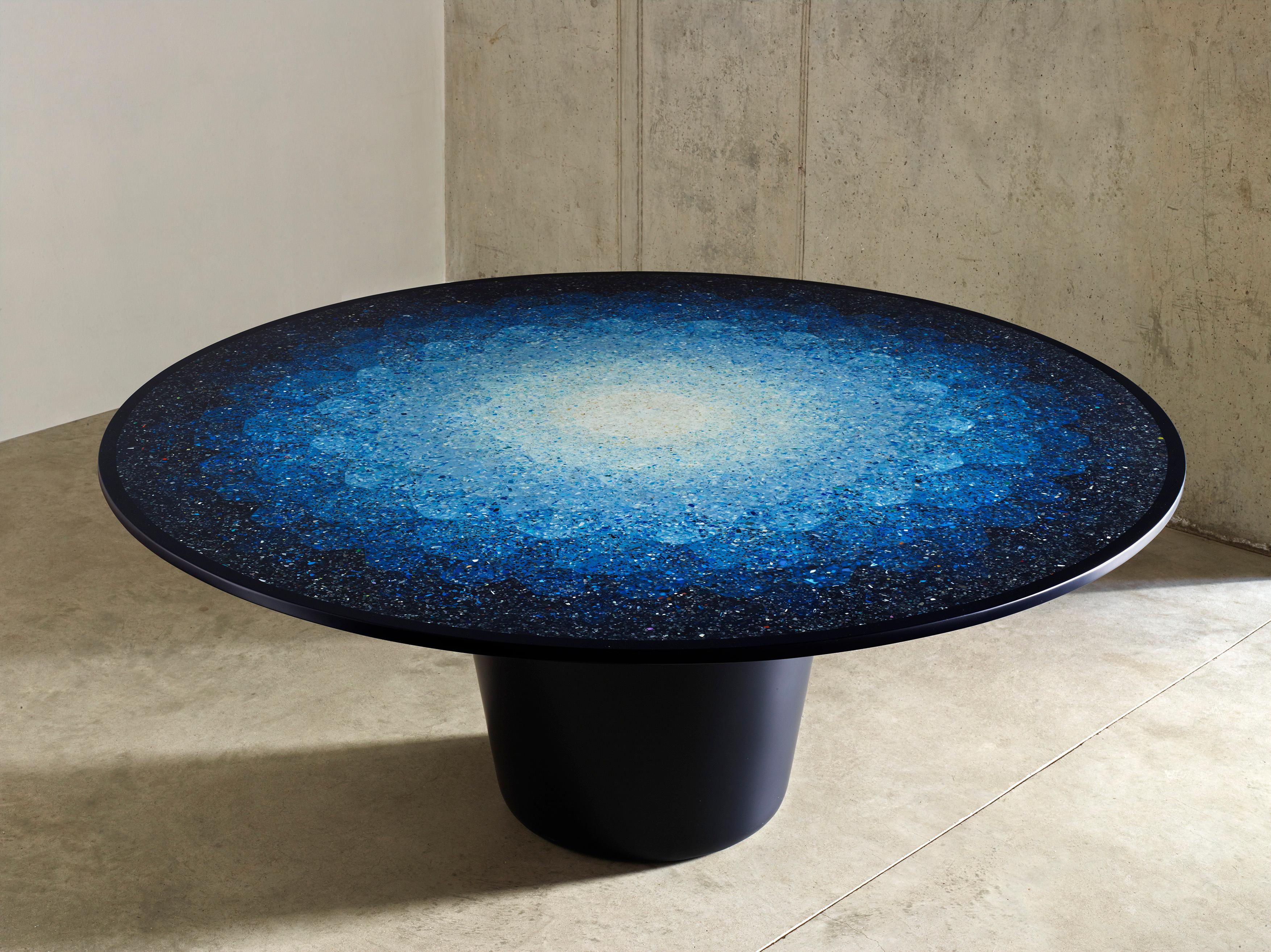 A contemporary rendition of a 19th century specimen table, Gyro substitutes examples of precious marbles, timbers and ivory with ocean terrazzo, an innovative composite material developed by Brodie Neill using fragments of ocean plastic. In striking