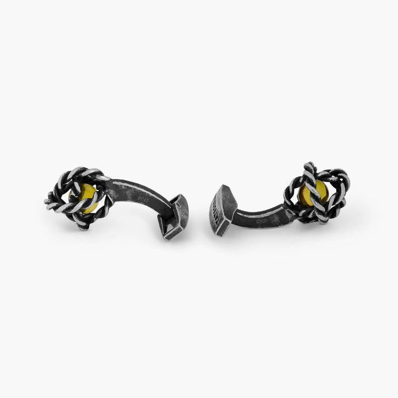 Gyroscope Glass Cufflinks in Antique Silver and Yellow Glass

These unique and delicate cufflinks have been formed from the hand-crafted rope effect rings interlocking each other to create a gyroscope effect. A single glass coloured bead has been