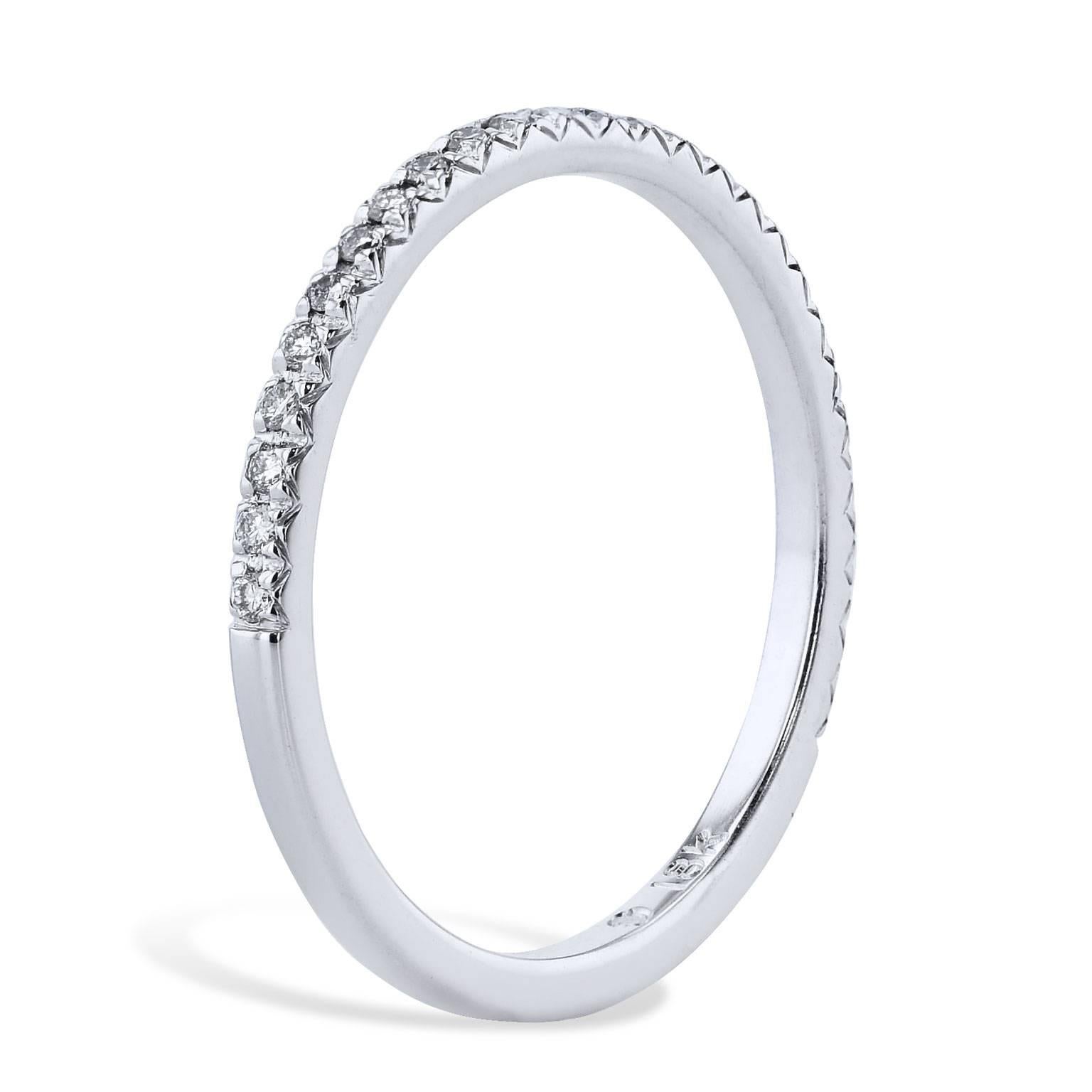 This handcrafted 18 karat white gold band ring features 0.13 carat of diamond. Each diamond is placed together to produce a ring that stirs and illuminates the essence of her beauty (size 5.5).