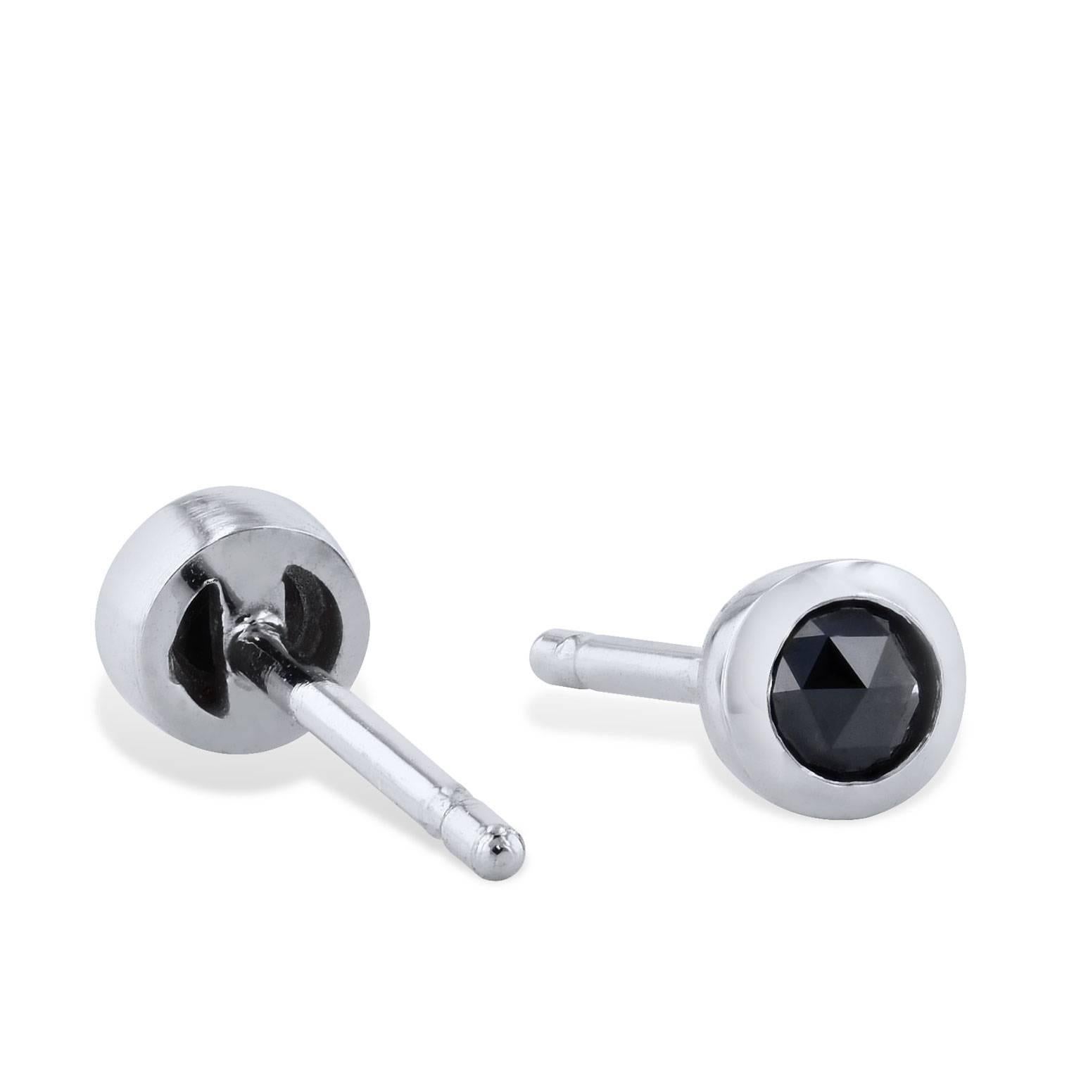 The perfect accessory to complete your sleek and stylish look. These handmade H and H 14 karat white gold rose cut black diamond stud earrings are just charming. Two black diamonds with a total weight of 0.20 carat are bezel set in this pair. They
