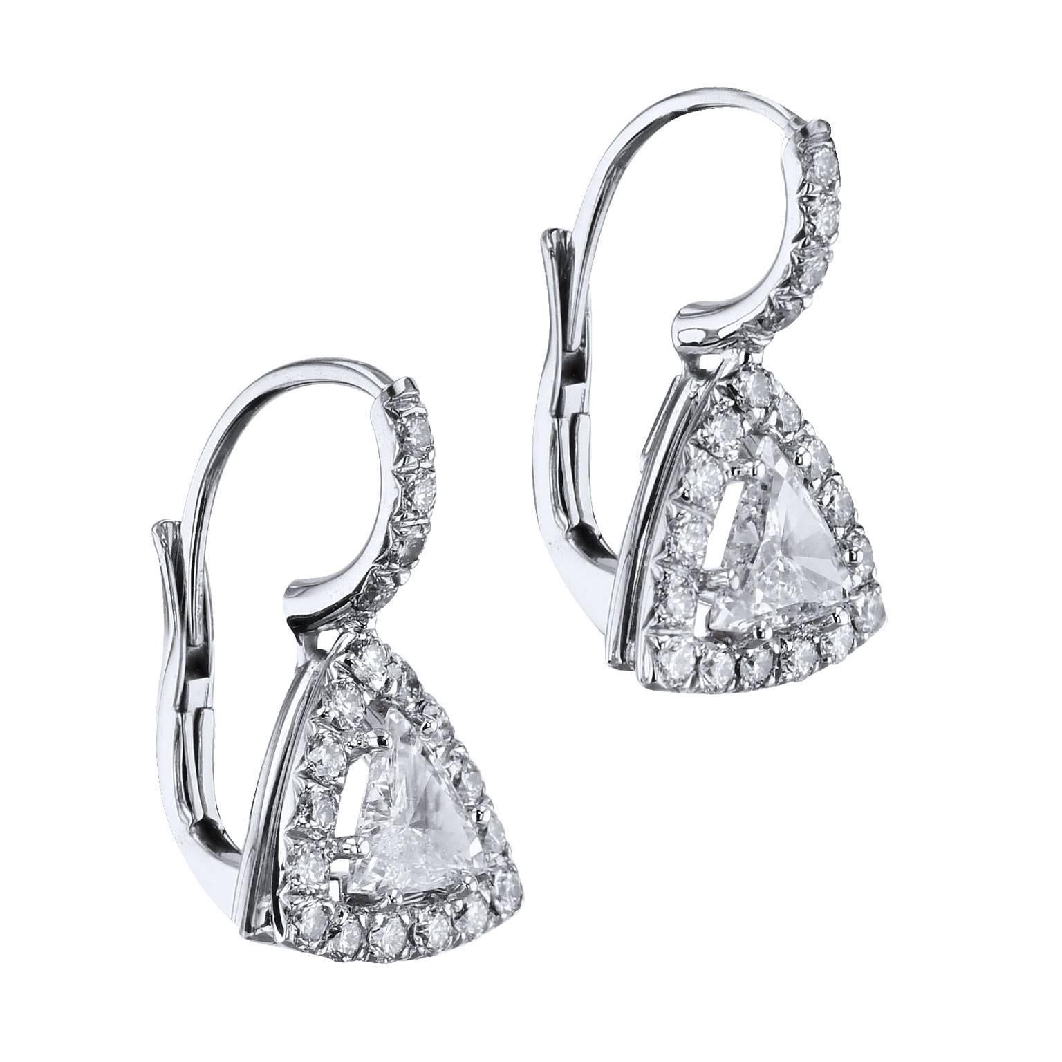 Two trillion-shaped diamonds, with a total weight of 0.80 carat (F/G/SI3), are set at center and embraced by thirty-eight pave-set diamonds with a total weight of 0.60 carat (G/VS2) in these handmade 18 karat white gold lever-back earrings. Give her