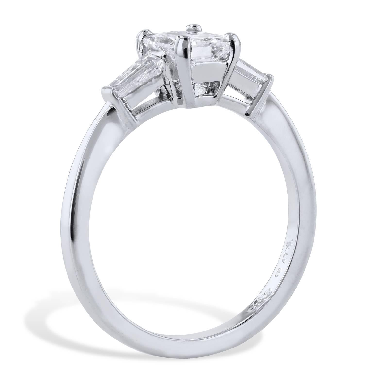 Leave her suspended in a dream with this beautiful H & H, handmade platinum diamond engagement ring. Two tapered baguette diamond side stones weighing a total of 0.30 carat (I/VS) draw the eye toward the lovely 1.00 carat diamond set at center (GIA