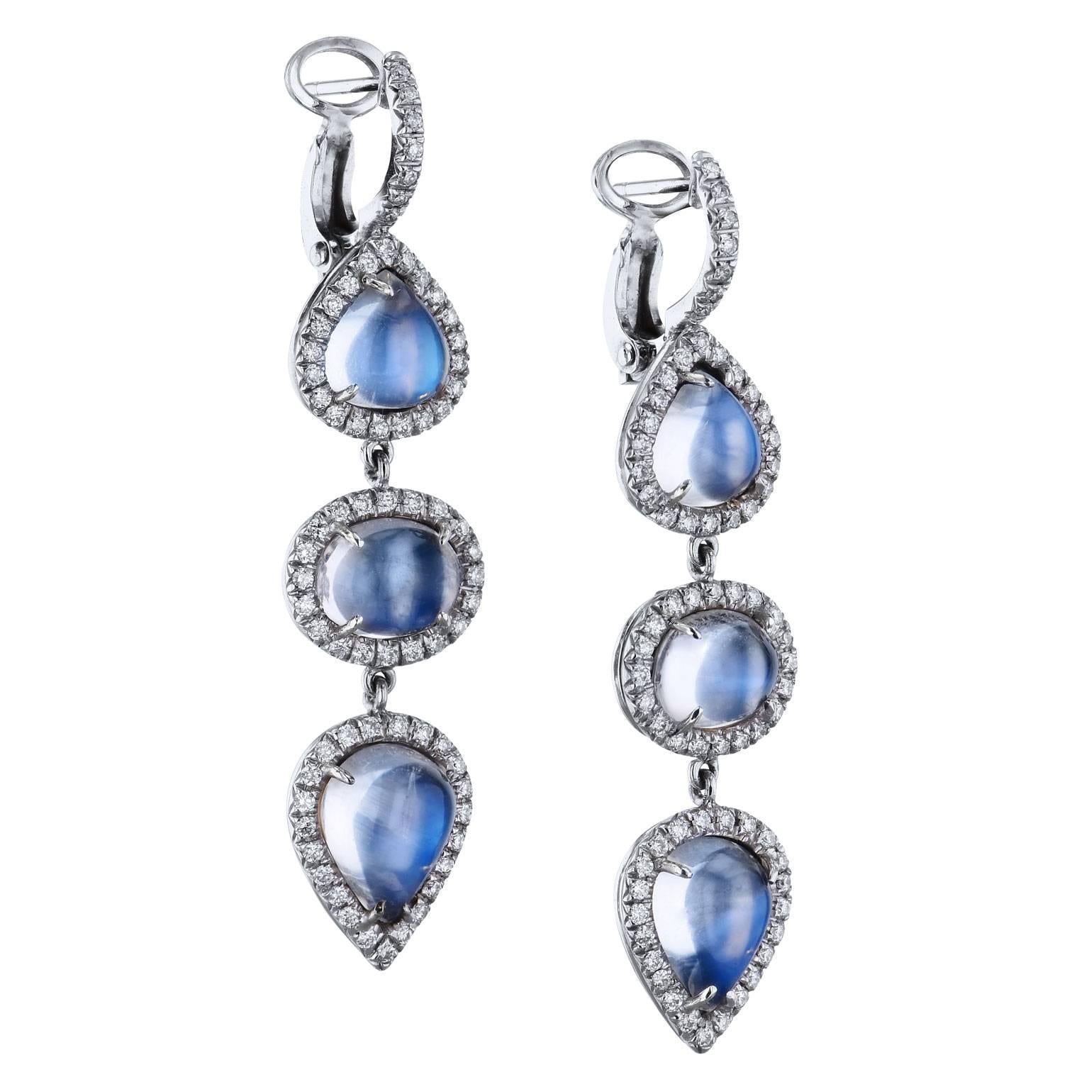 Ethereally fashioned in 18 karat white gold, six pear and oval-shaped moonstones, with a total weight of 12.50 carat, are embraced by 1.17 carat of pave-set diamonds (G/H/VS) in these handmade dangle earrings by H.
