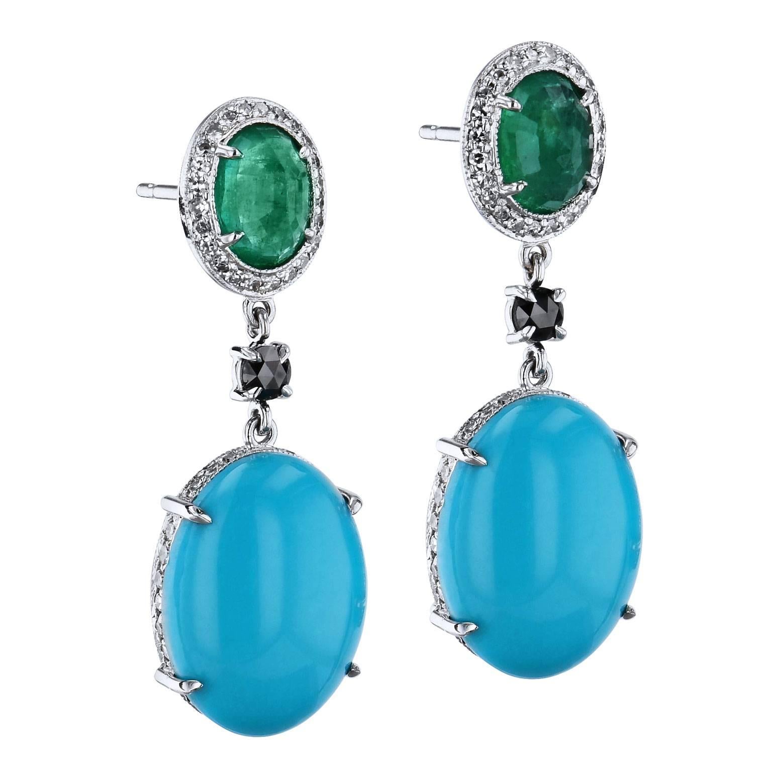 Luscious, handmade drop earrings designed by H and fashioned in 18 karat white gold, feature two emerald cabochons above with a total weight of 2.32 carat, while two turquoise cabochons with a total weight of 12.72 carat, hang with poise below (16