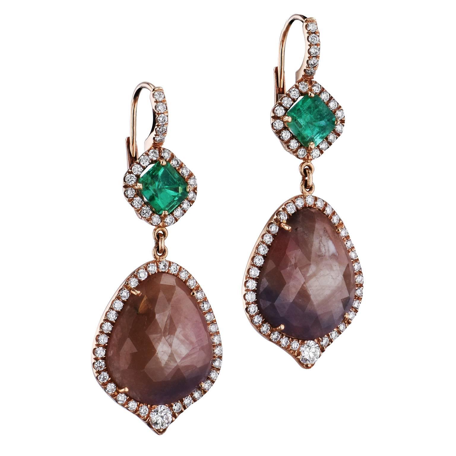 Hues of light brown and crystalline green dance together, enchanting the eye and highlighting texture.  These stunning earrings are handmade and one of a kind by H&H Jewels.  They feature 20.00 carat of light brown sapphire slices are embraced by