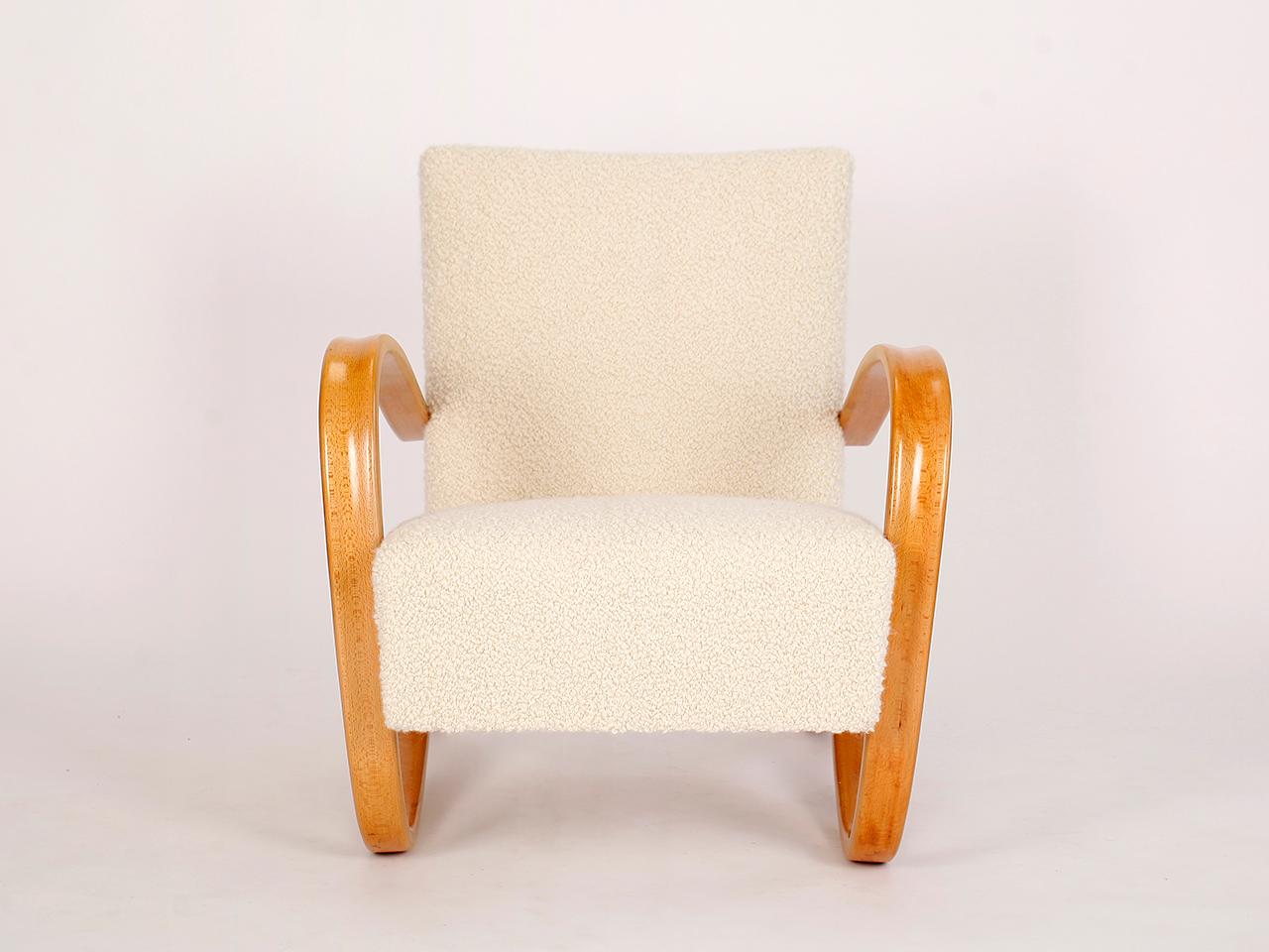 This lounge chair by Jindrich Halabala for Spojene UP Zavody was produced during the 1930s. The piece has been completely restored with a new spring. The wooden parts restored. Covered with an Italian fabric made of soft wool and alpaca by Dedar.
