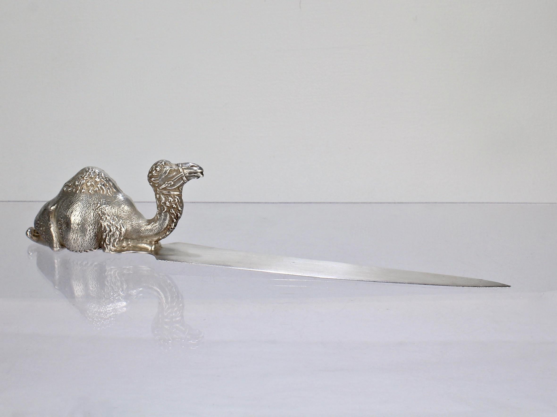 A wonderful figural sterling silver letter in the form of a one hump camel.  

The camel wears a wry expression on its face and has a finely detailed, sculptural quality.   

This is one of line of several very high quality camel items that H A Cary