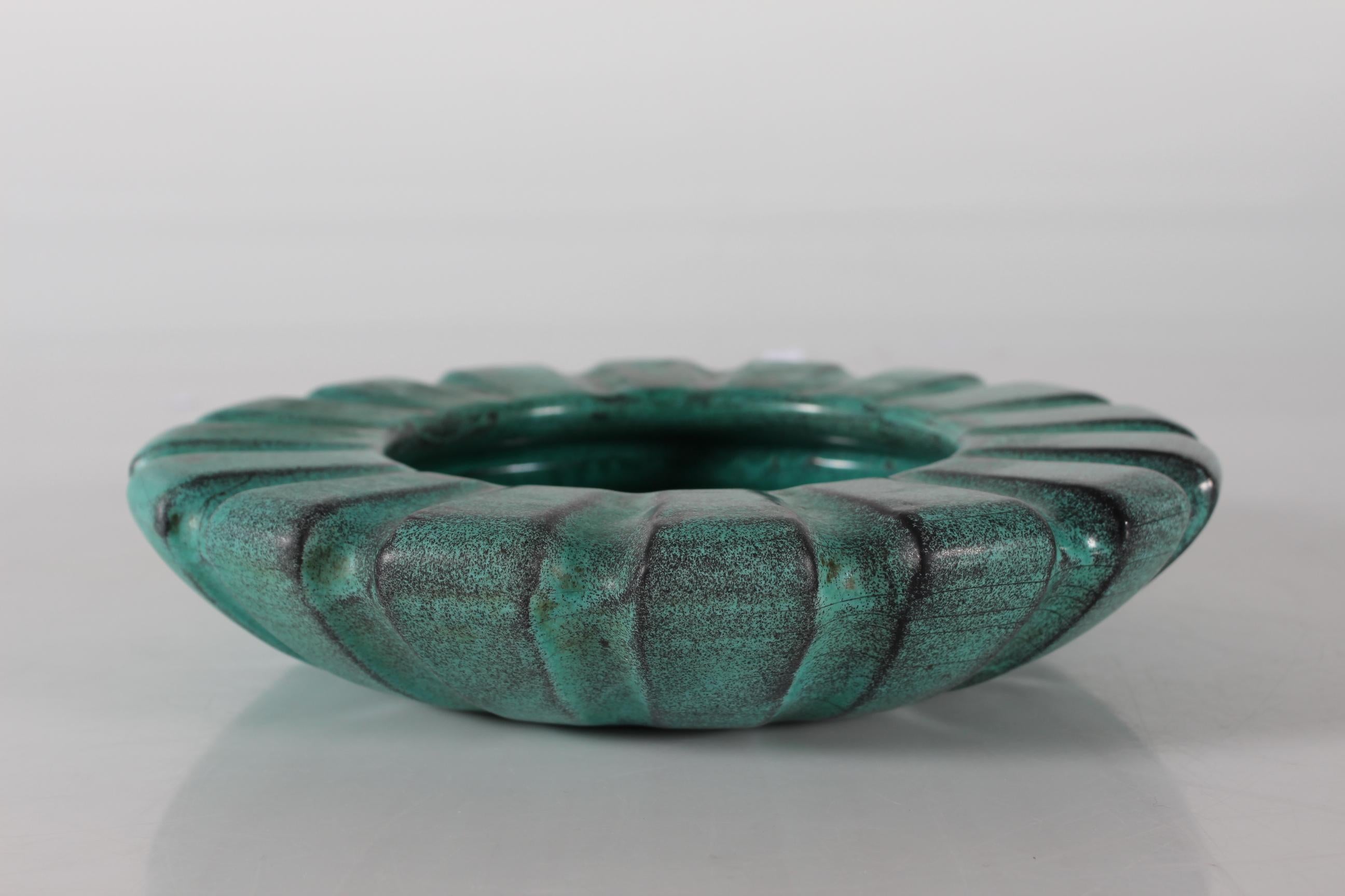 Large Art Deco rippled ceramic bowl by Svend Hammershøi (1873-1948) for the pottery work-shop Kähler. 
Made in 1930s for a company as gift for their clients with indistinct stamped logo.

The bowl is decorated with turquoise glaze with darker