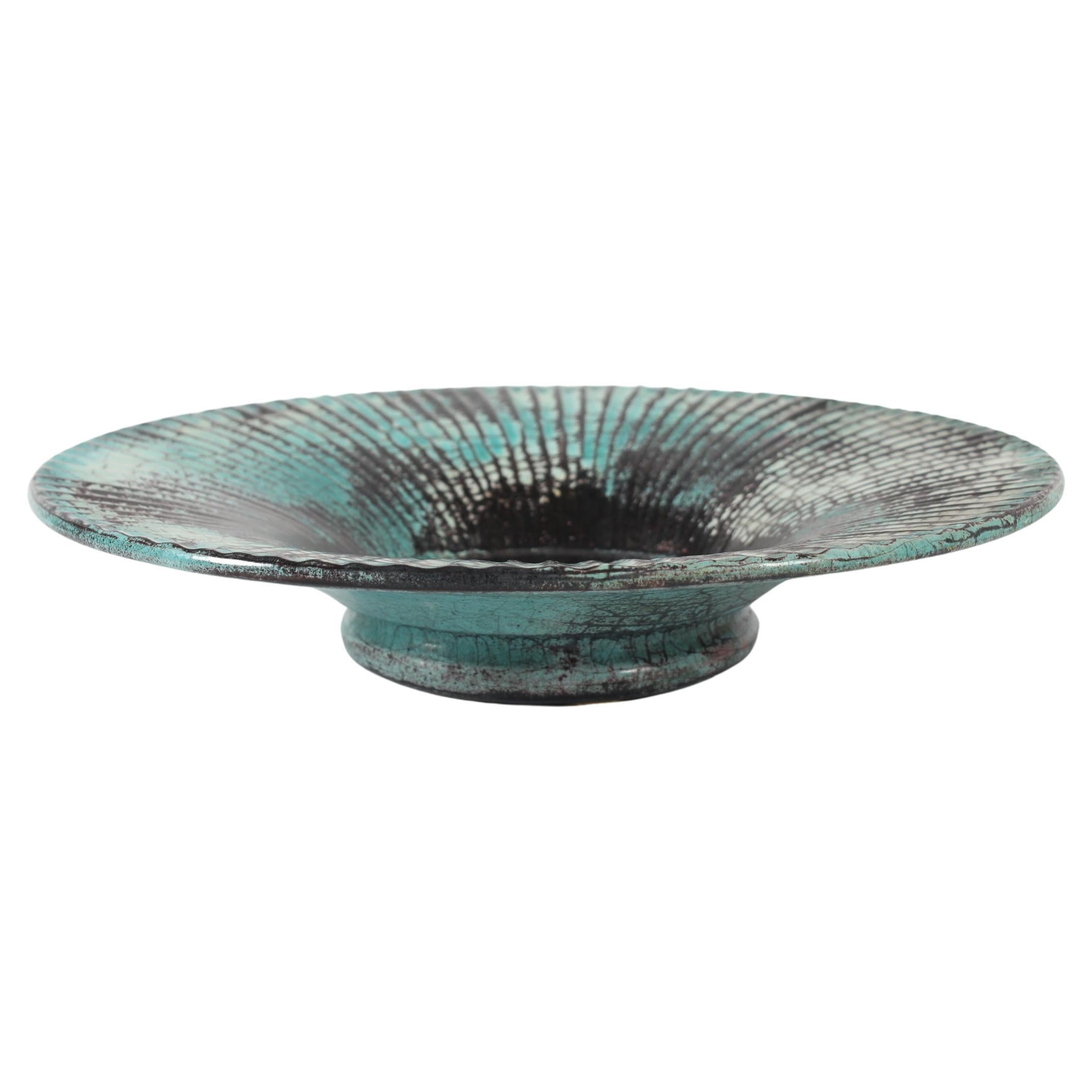 Large Art Deco ceramic platter/ low bowl by Nils Kähler in the 1930s for the pottery work-shop Kähler in Næstved, Denmark.

The bowl has a grooved fluted design with verdigris green, black and beige glaze.
This type of glaze was also often used by