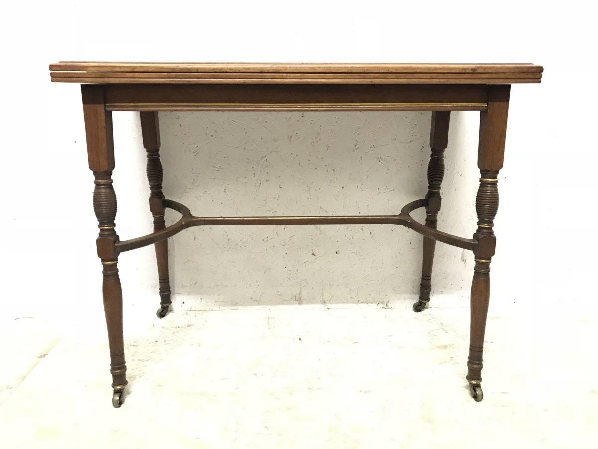 H W Batley, attributed Collinson & Lock. A fine quality Anglo-Japanese rosewood fold over card table opening to reveal the original gold baize with embossed sunflower details to the corners. The slightly splayed, turned and incised legs united by a
