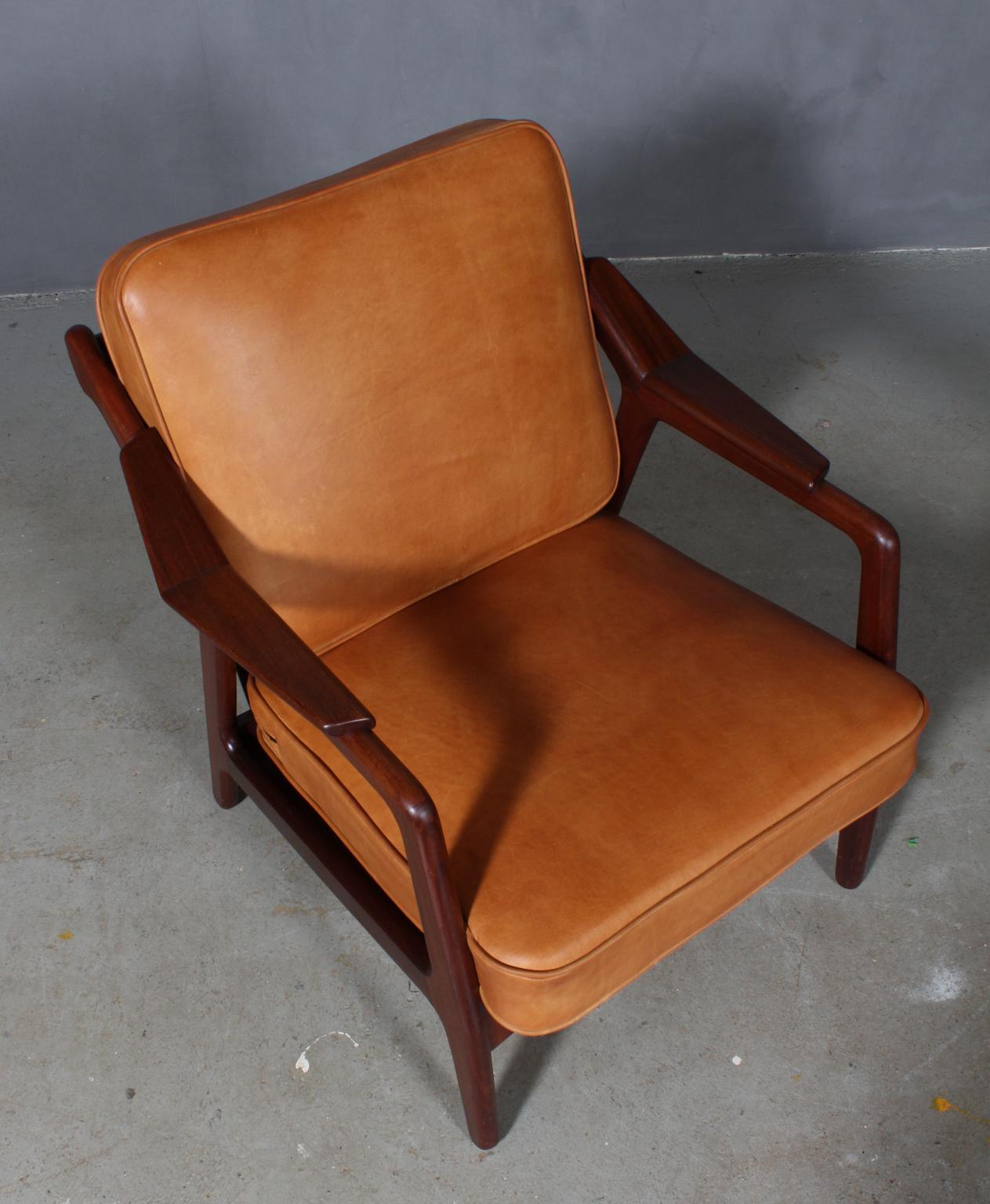 H. Brockmann Petersen lounge chair with frame of solid teak.

New upholstered with vintage tan aniline leather.

 
