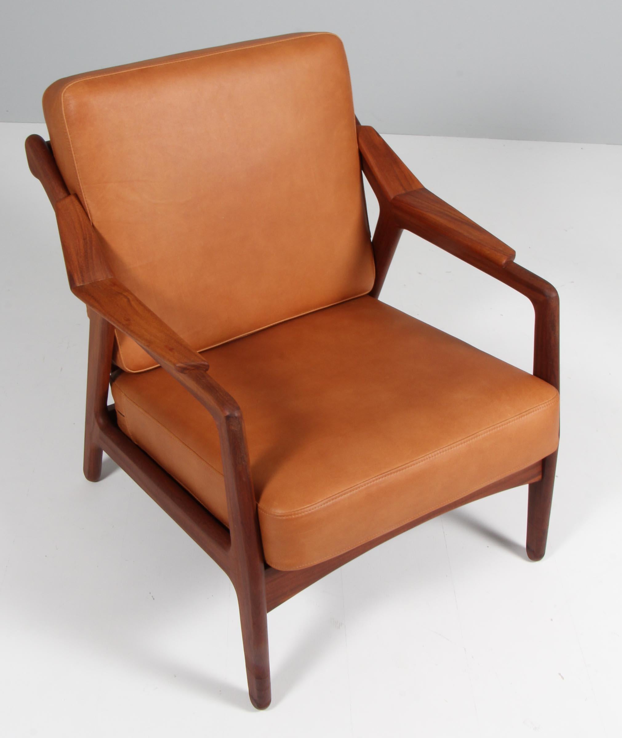 H. Brockmann Petersen lounge chair with frame of solid teak.

New upholstered with vintage tan aniline leather.

