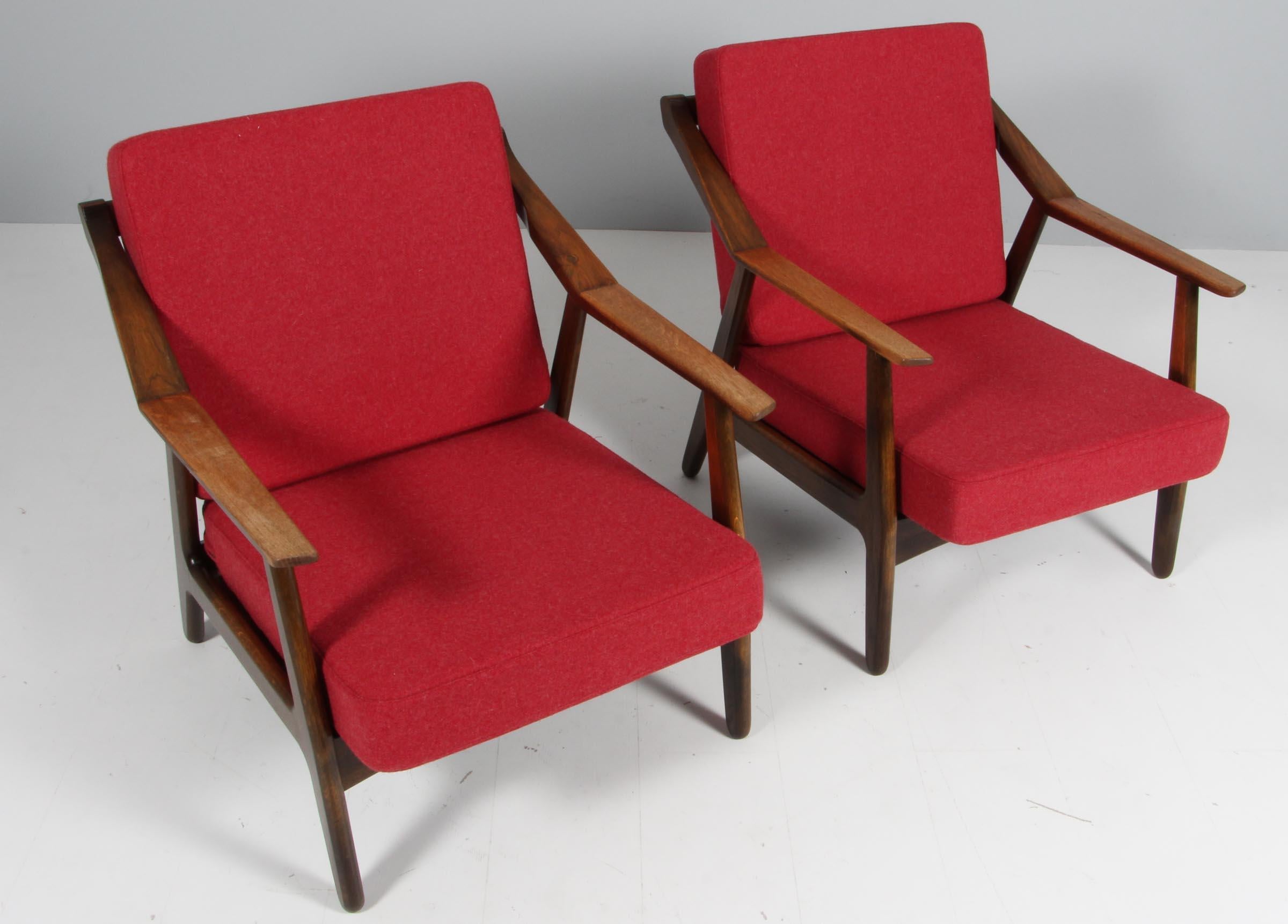 H. Brockmann Petersen pair of lounge chairs with frame of solid teak.

New upholstered with red 100% New Zealand wool.

