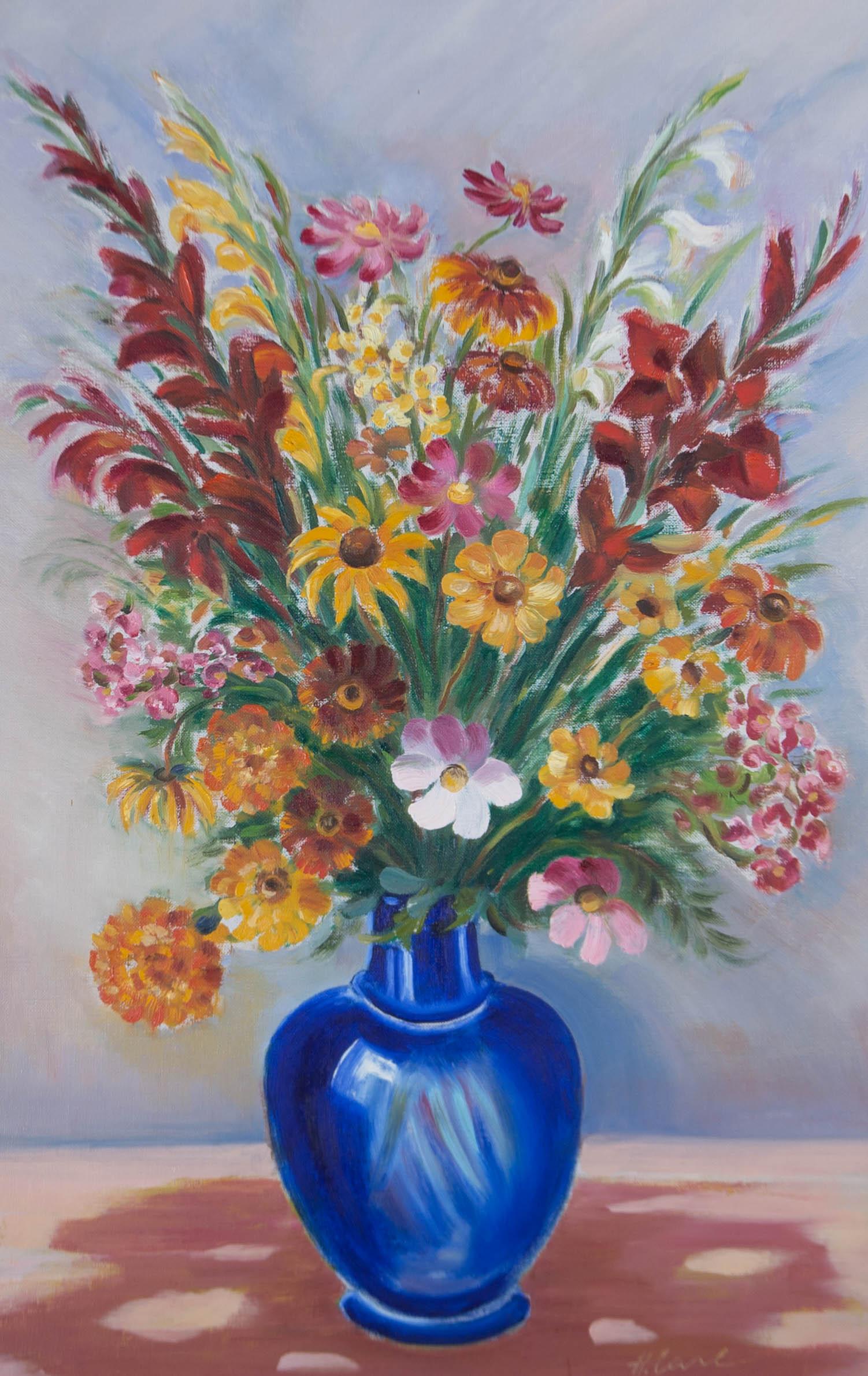 An eye-catching oil depicting numerous red, orange, and pink flowers filling a blue vase on a pink surface against a blue background. Presented in a distressed silver gilt-effect frame. Signed to the lower-right edge. On canvas on stretchers.
