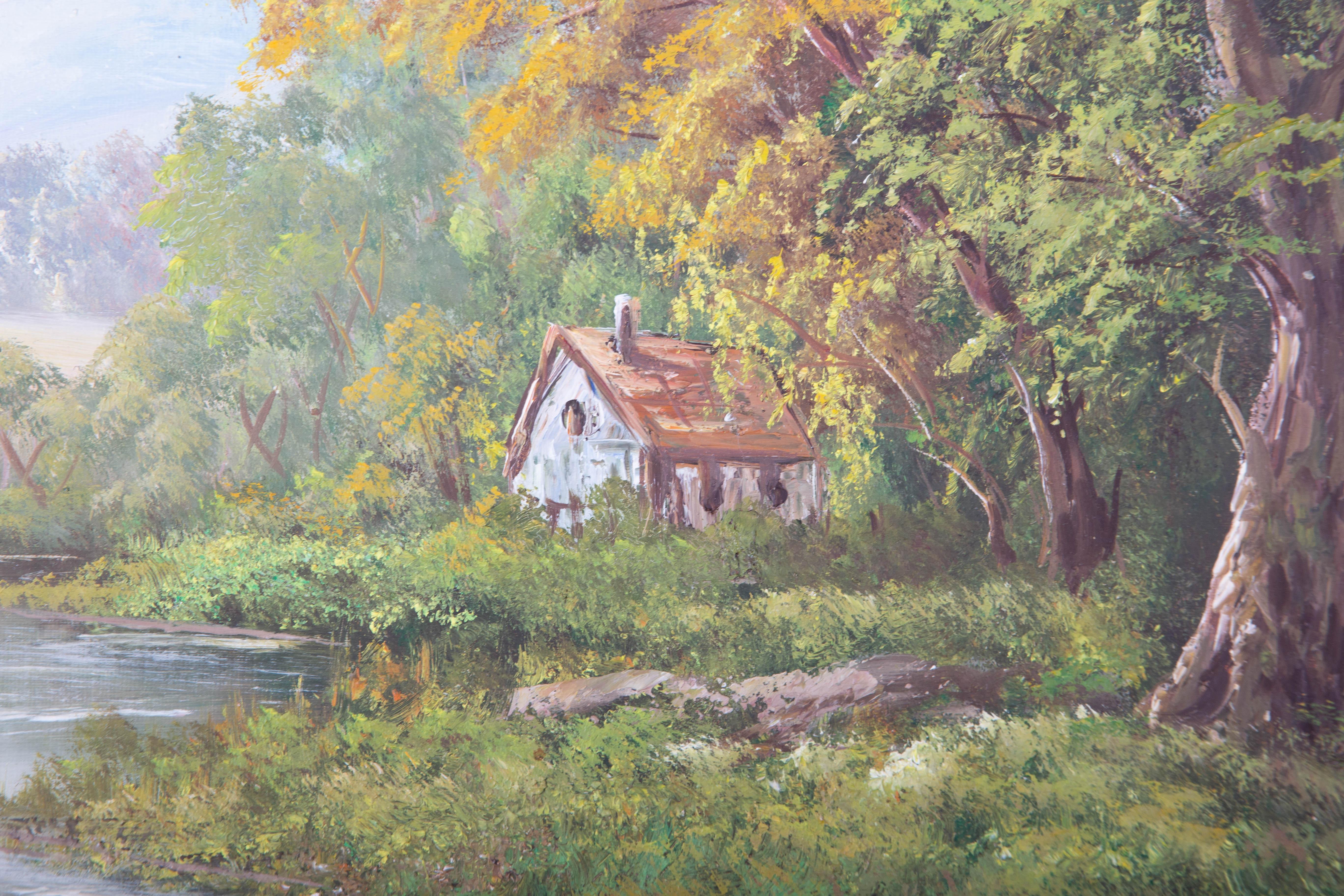 A vibrant and attractive oil painting, depicting a rural landscape scene with a small cottage by a river. Signed to the lower right-hand corner. Presented in an ornate, gilt effect frame. On canvas on stretchers.
