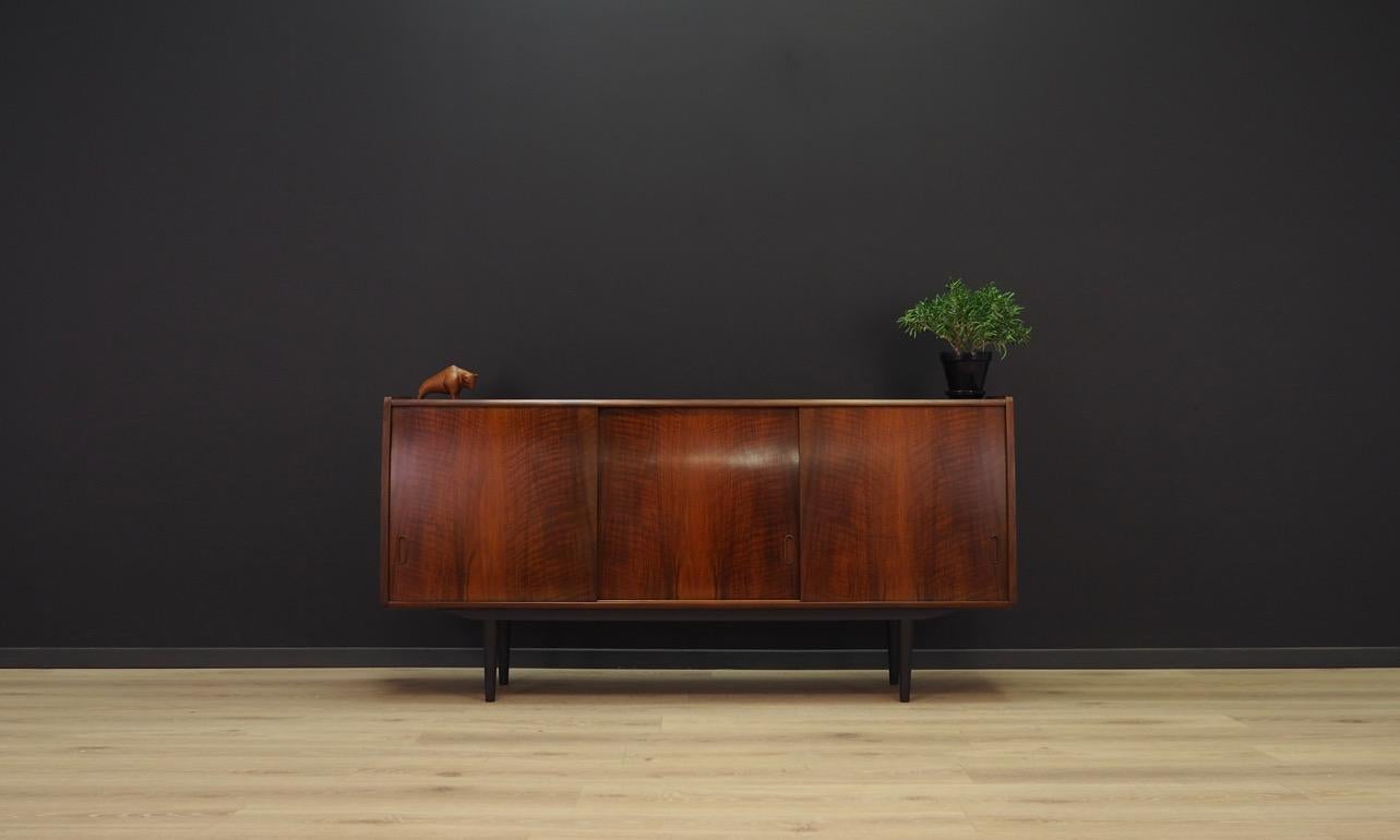 Classic sideboard from the 1960s-1970s, a minimalist form finished with mahogany veneer, designed by Holger Christensen. A spacious interior with shelves and a decorative mirror behind the sliding doors. Preserved in good condition (small bruises