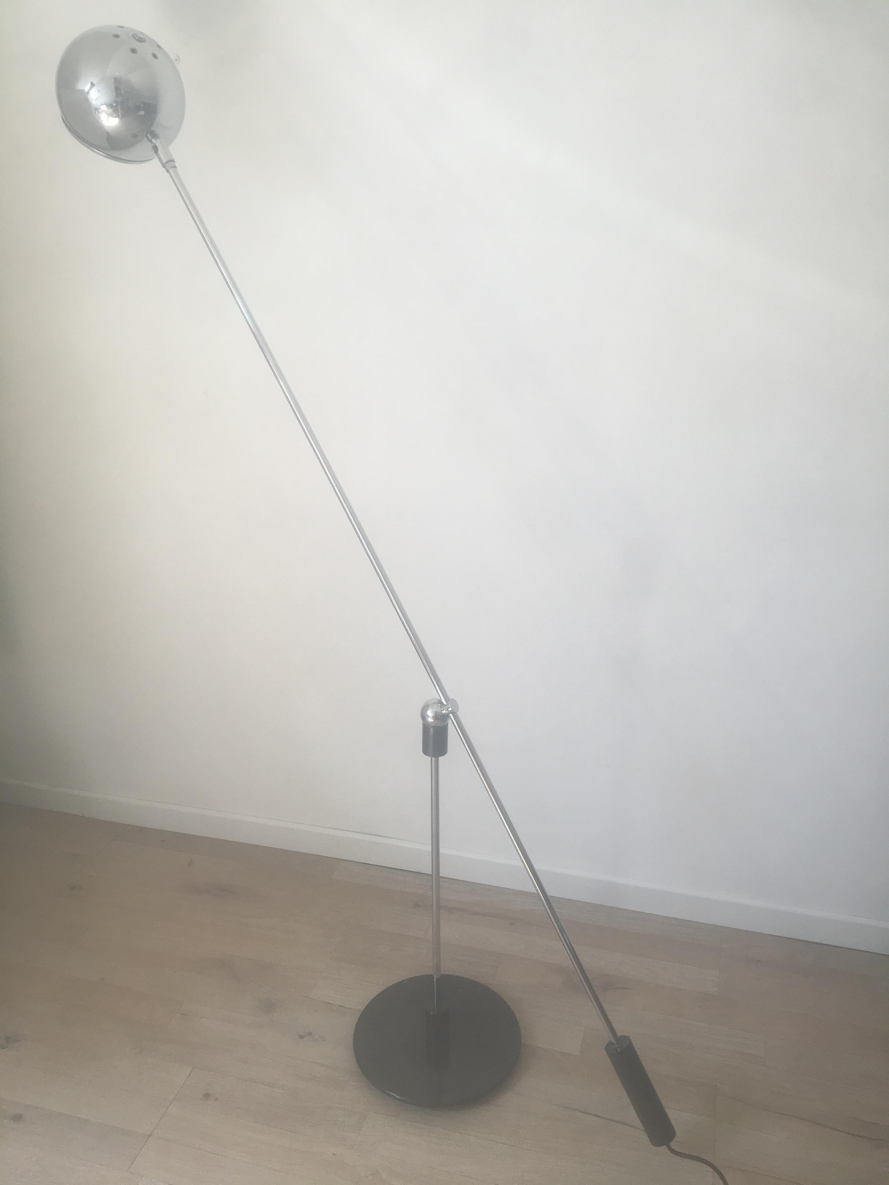 Amazing magnetic floor lamp designed by H Fillekes for Artiforte in Netherlands in 1960's.
The round chromed metal ball contains a strong magnet which keeps the long arm at the center foot. The brown lacquered counterweight makes it possible to