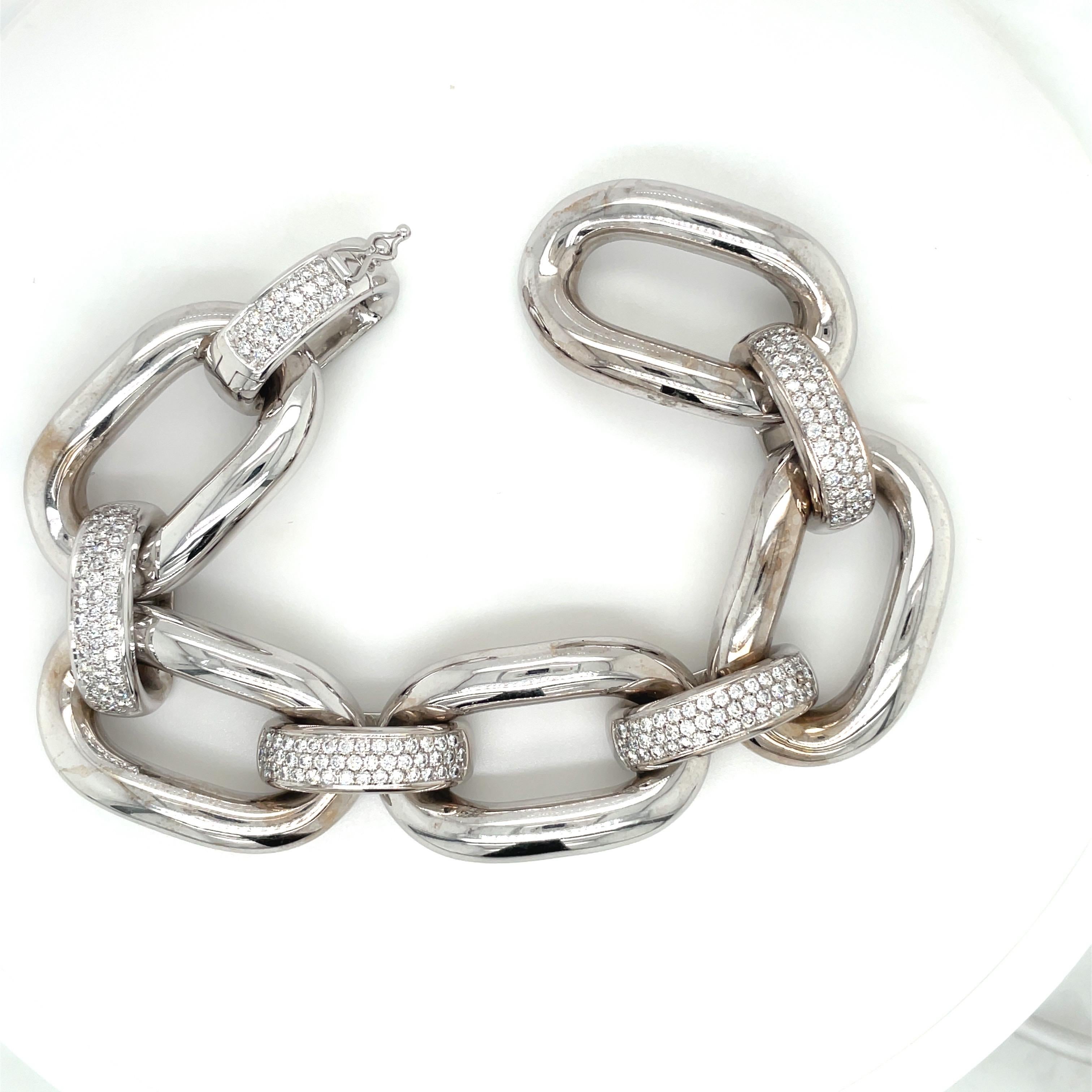 18 karat white gold bracelet designed with 5 oval links and 5 pave diamond connectors. The bracelet is 8