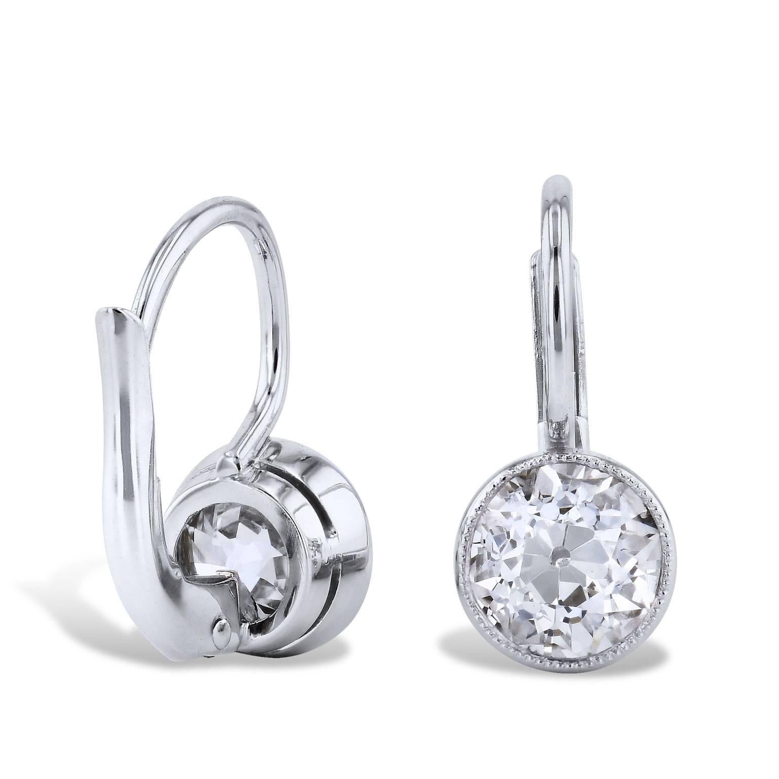 These swank handmade earrings epitomize elegance and are essential for the woman who likes a little glamour. Two diamonds with a total weight of 1.59 carat (K/L/VS) are bezel- set and fashioned in platinum. These lever-back earrings endure.